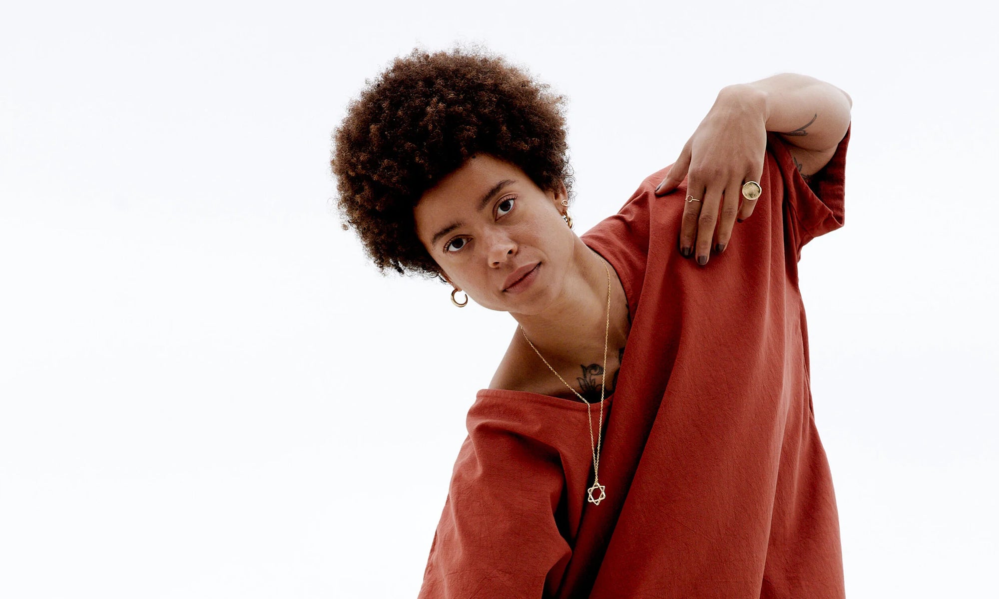 Niki wears the Ra Pinky Signet and Circle Ring, along with the Rollo Hoops and Solomon's Seal Necklace. Hand carved and cast in recycled 14k gold using traditional lost wax casting techniques.