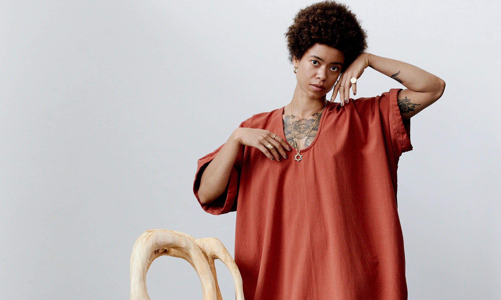 Model Niki shows off the recycled gold Ra Pinky Signet Ring along with the Solomon's Seal Necklace, and other handmade treasures from the Alchemy Collection.