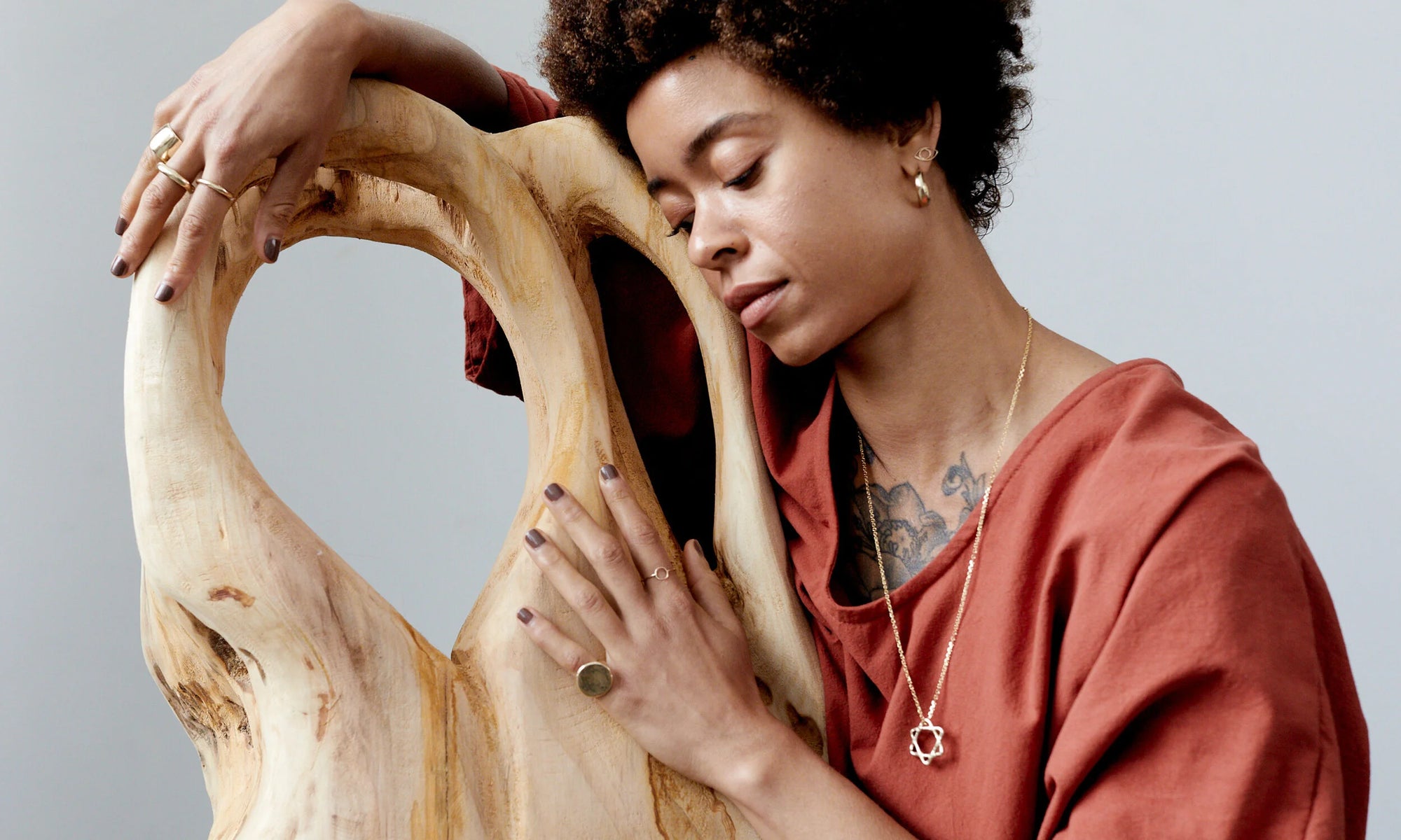 Niki wears the Ra Pinky Signet, Rollo Band, Circle Shape Ring, along with the Rollo Hoops, Protective Eye Stud, and Solomon's Seal Necklace. All handmade using recycled 14k gold.