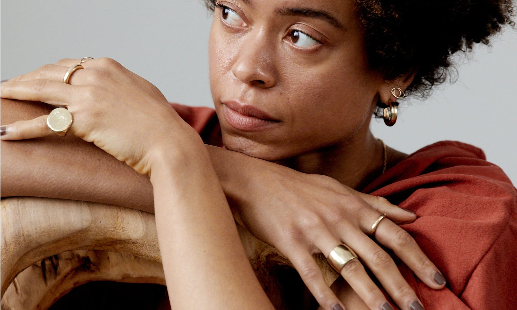 The Ra Pinky Signet Ring is worn along with the Rollo and Petite Rollo Bands, the Demeter Cigar Ring, Circle Ring, Rollo Hoops, and the Protective Eye Stud. All items handmade in recycled 14k gold.