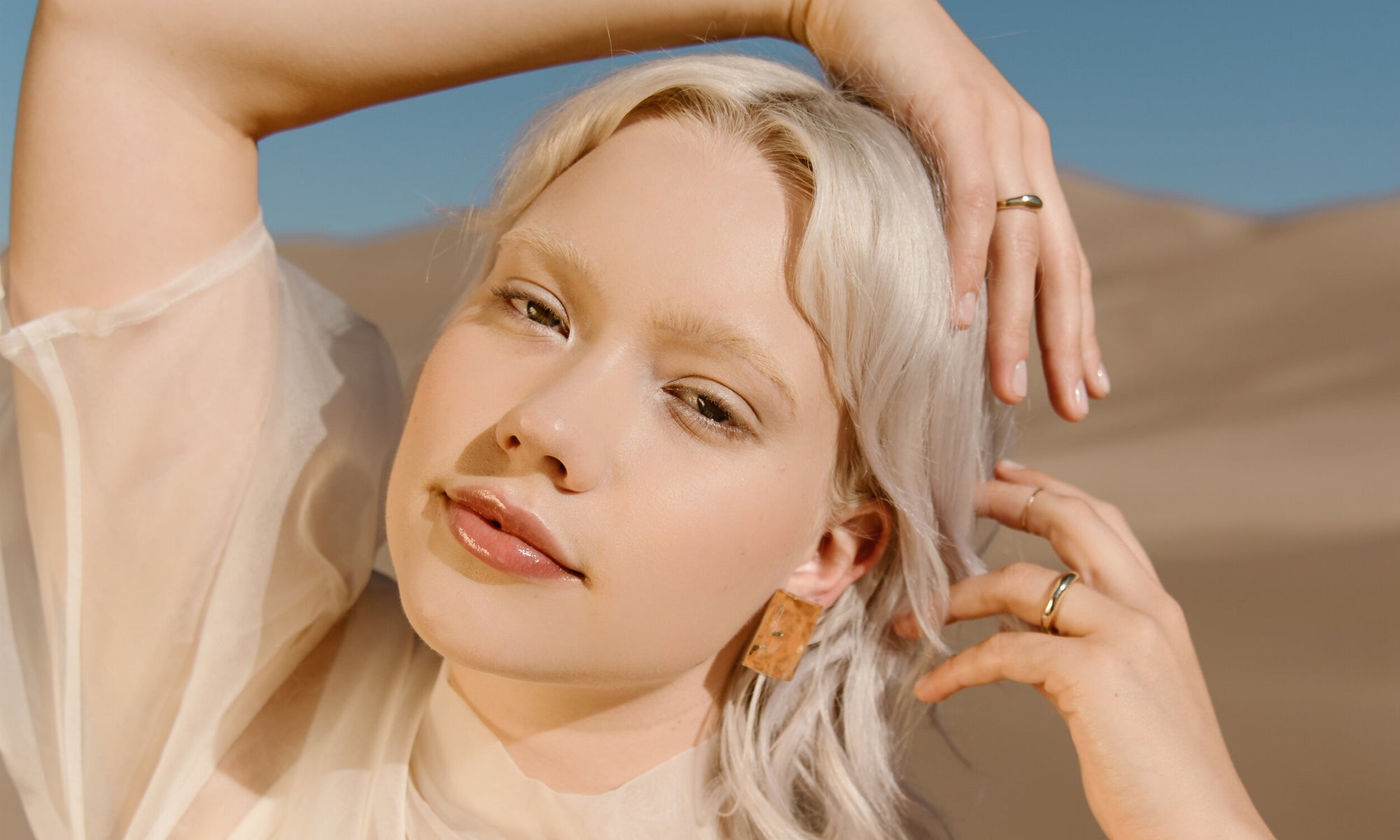 Model Aleah Hyvonen wears the Plane Earrings, Portal Bracelet, Portal Ring, and Rollo Band. All sustainably handmade in recycled 14k gold using traditional lost-wax casting techniques.