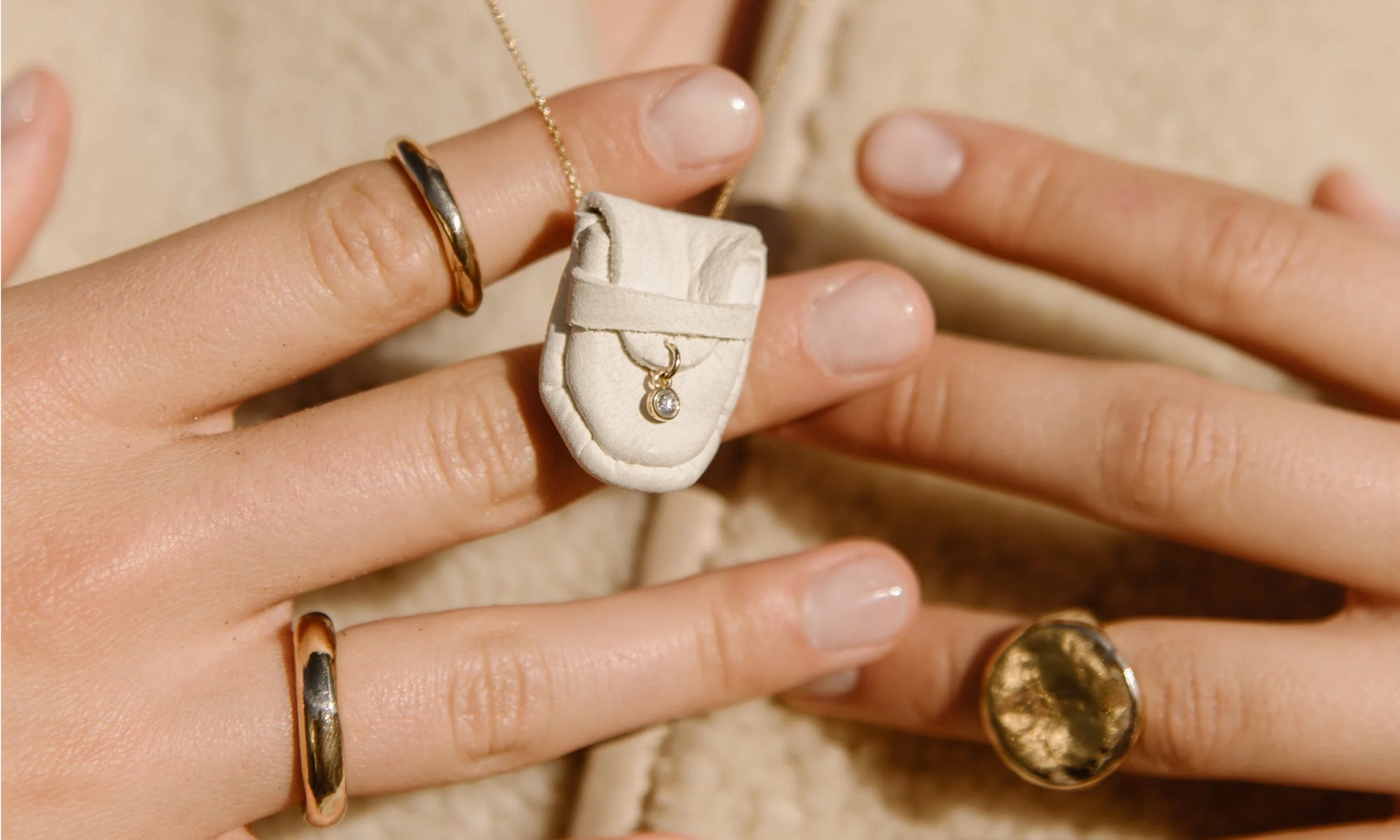 Model Aleah Hyvonen wears the Brilliant Diamond Talisman Pouch Necklace, and the Petite Rollo Band, Rollo Band, and Ra Signet Ring. All sustainably handmade in recycled 14k gold, using traditional lost-wax casting techniques.