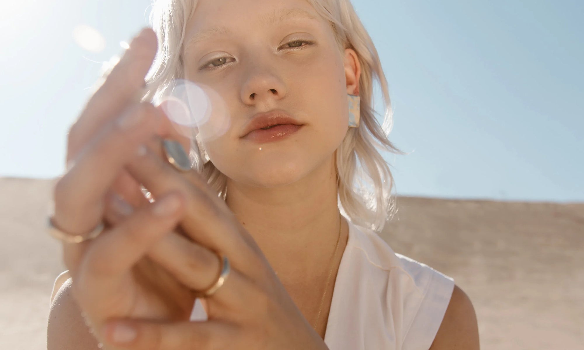 Model Aleah Hyvonen wears the Plane Earrings, Ra Signet Ring, Rollo Band, and Portal Ring. All sustainably handmade in recycled 14k gold, using traditional lost-wax casting techniques.
