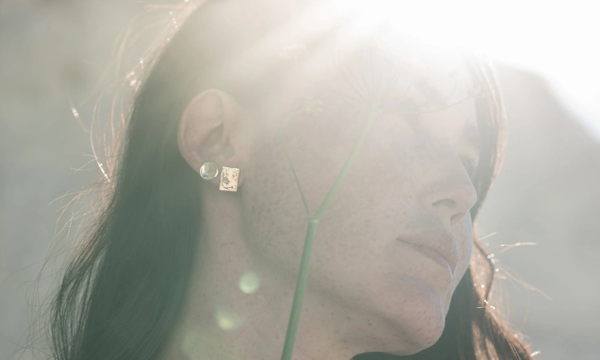 Sunshine wears the New Orb Studs and Petite Plane Studs, both a study in geometry, particularly when worn together. Both handmade in recycled 14k gold.