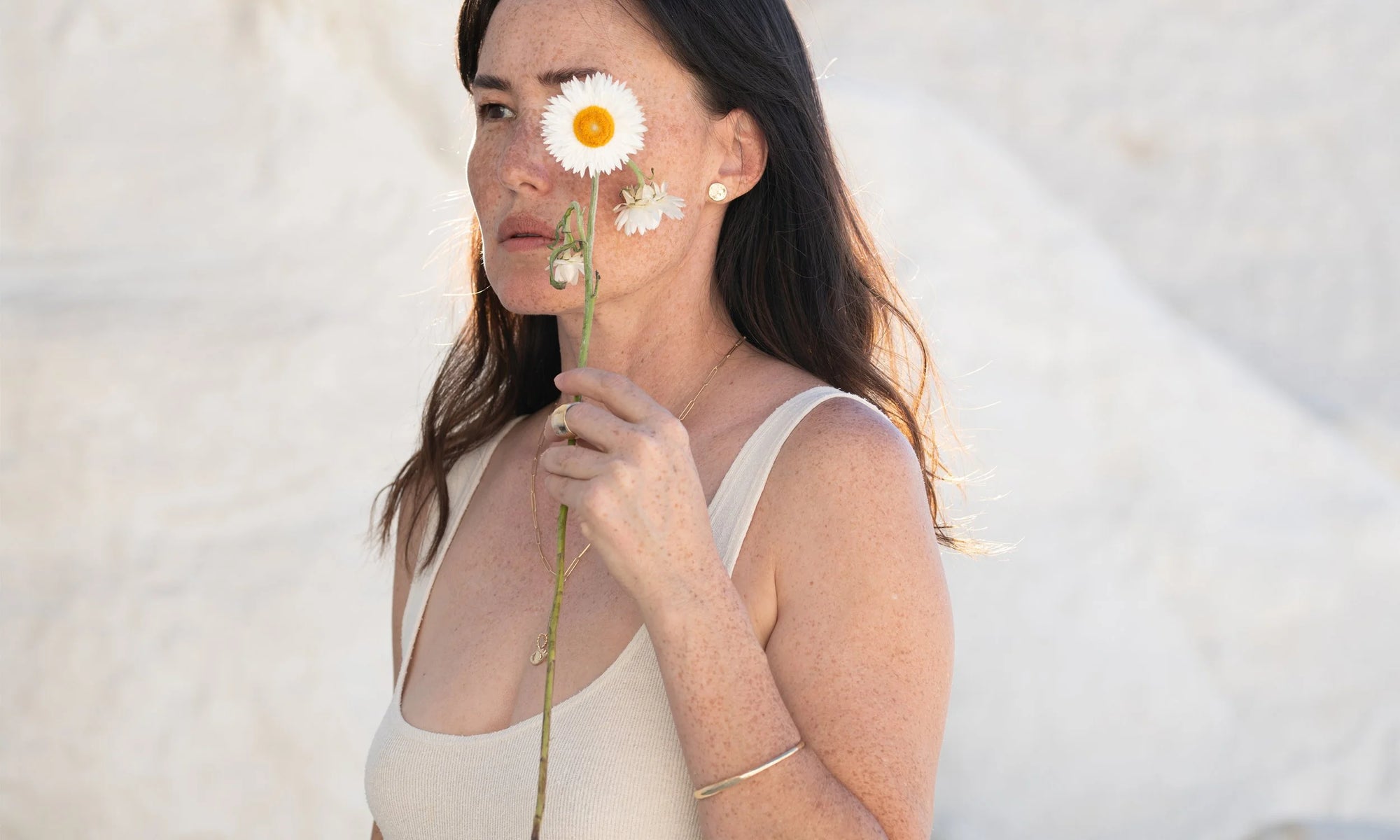 From top: New Orb Studs, Demeter Cigar Band, Protective Eye Y Necklace, and Portal Bracelet. All handmade in recycled 14k gold.