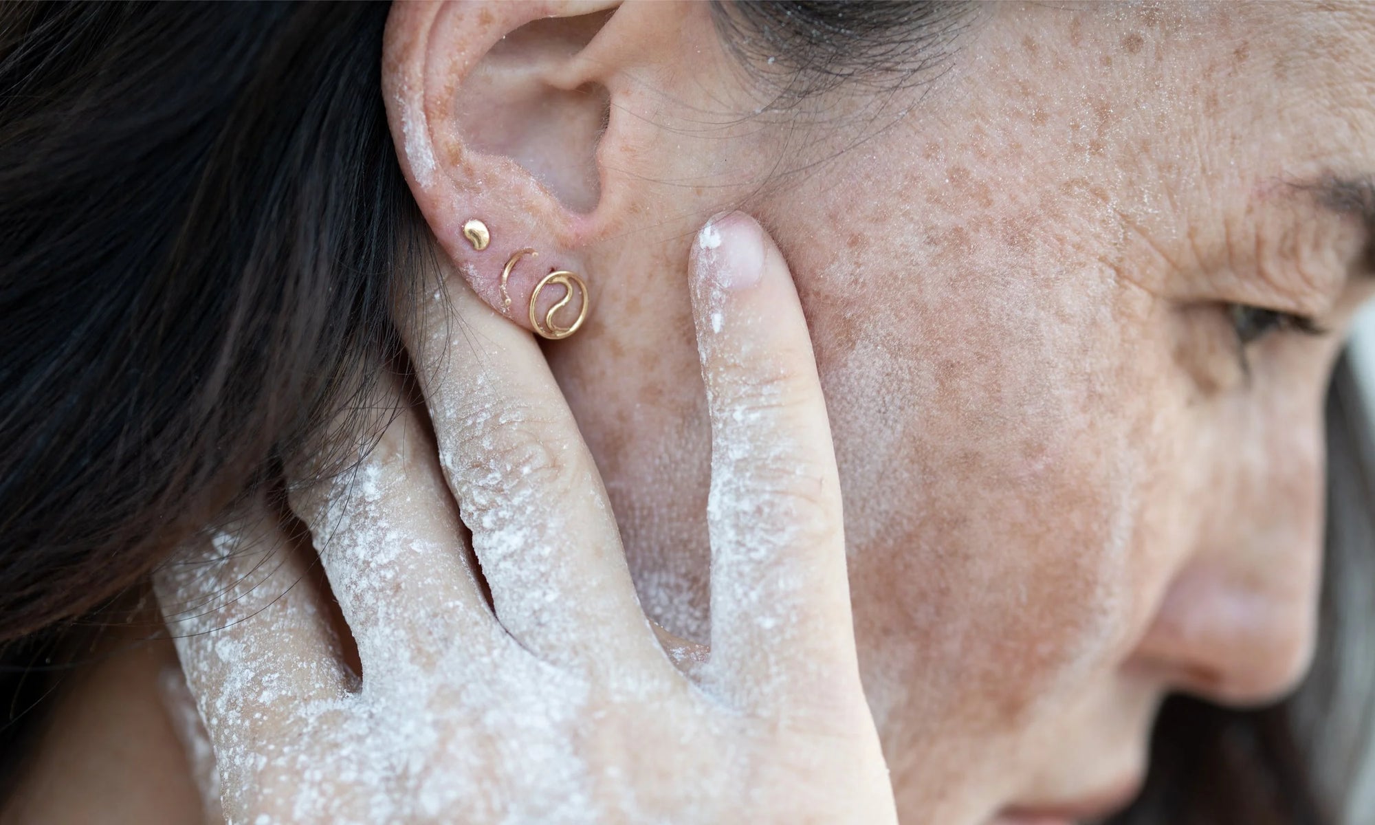 Earring group, from left: The Mini Orb Stud, Outward Arc Stud, and Yin Yang Stud. All sustainably handmade in recycled 14k gold.