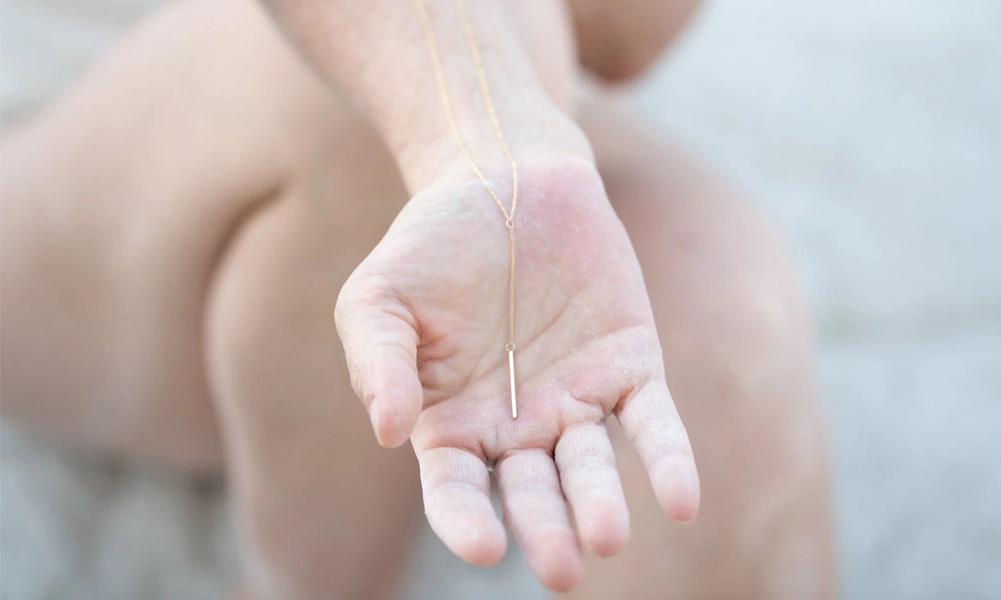 The Linear Y Necklace, handmade in recycled 14k gold.