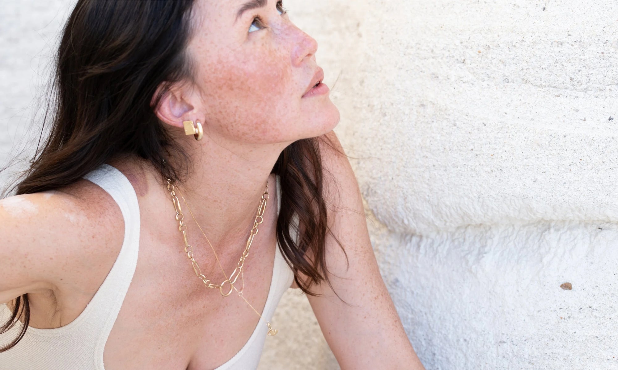 Looking up. Sunshine in the Petite Plane Earrings, Rollo Hoops, Metanoia Chain and Mini Protective Eye Y Necklace.