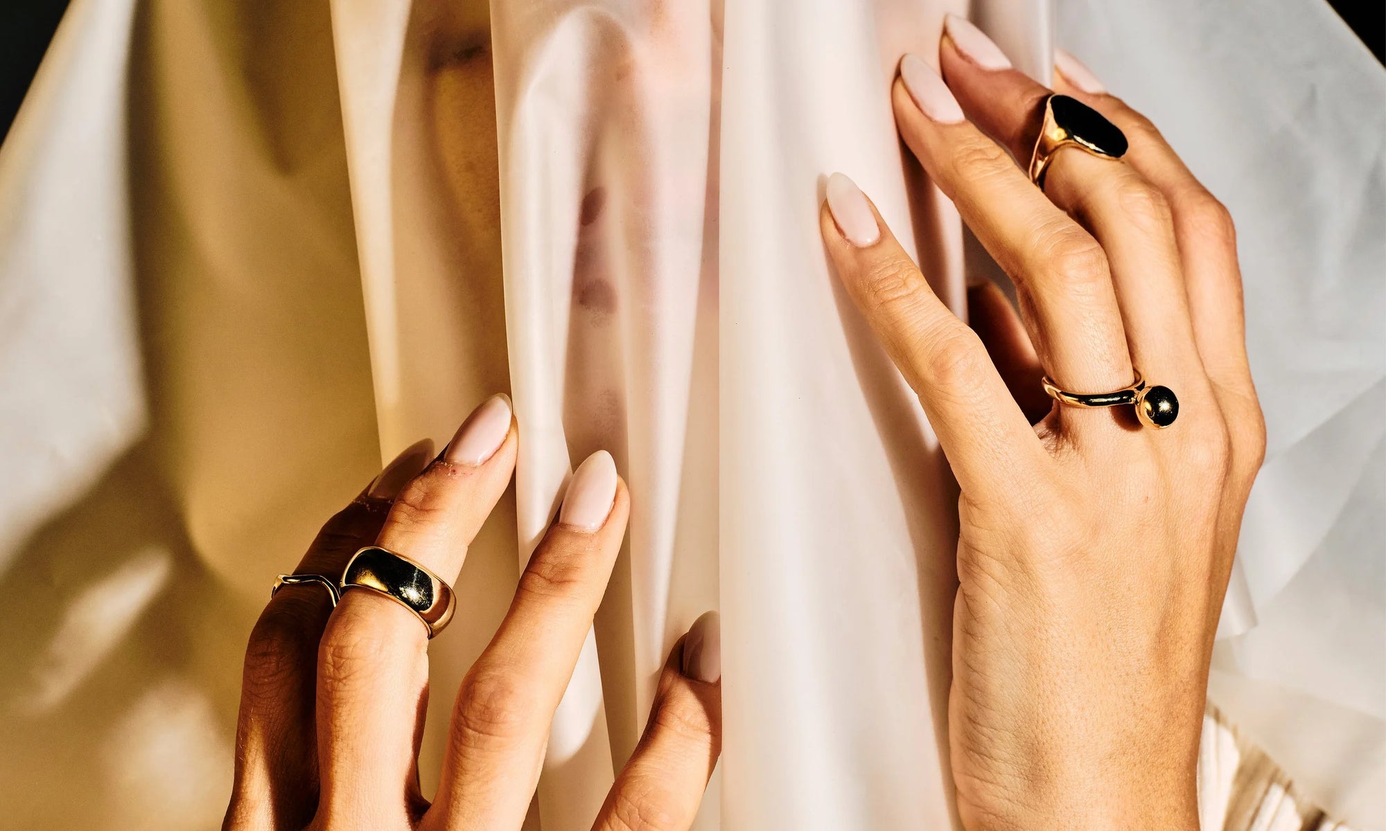 Model Vanessa Luka wears, from left: the Conjunct Cigar Band, Central Sun Ring, and Ra Pinky Signet. All hand-sculpted and cast in recycled 14k gold.