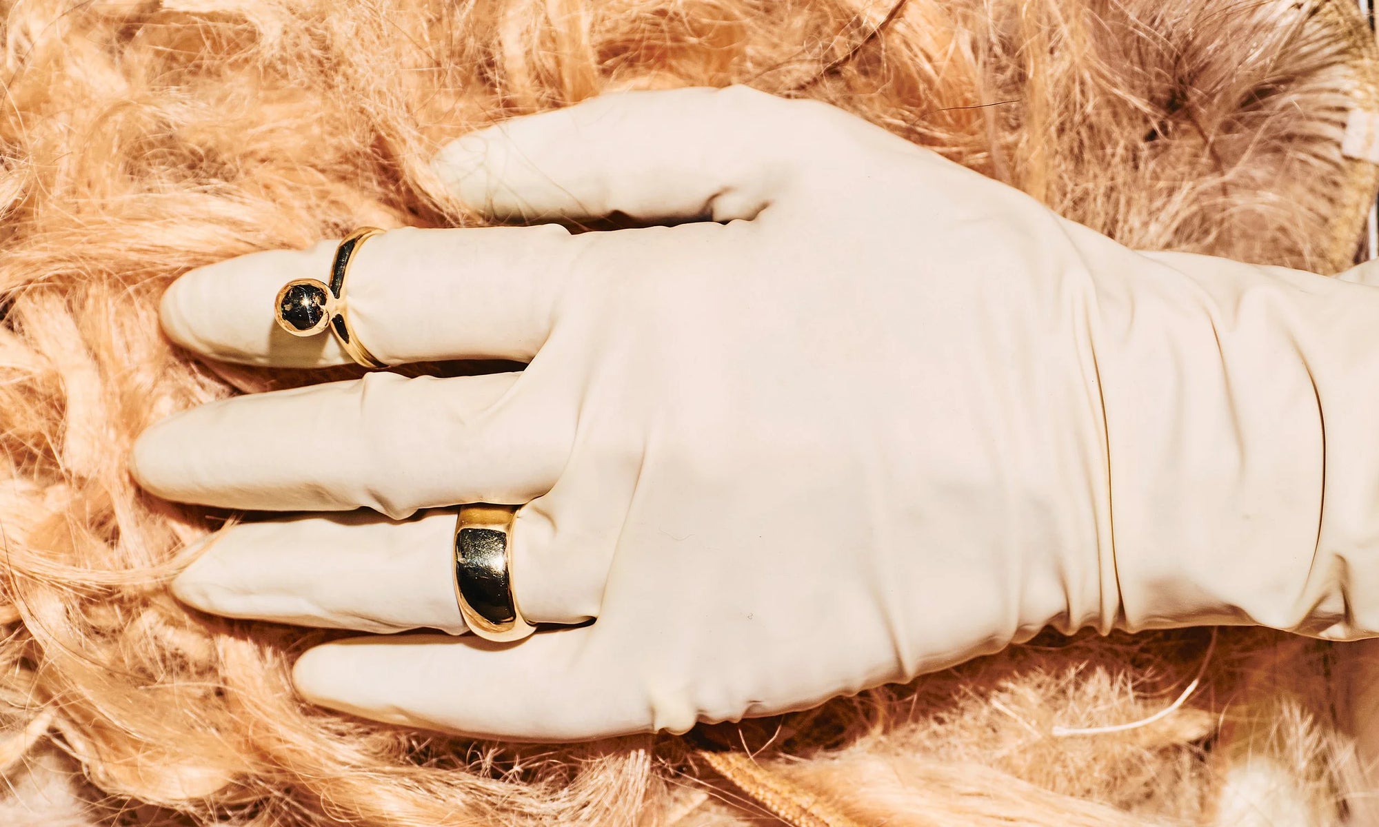 Our gloved mystery model wears the new Central Sun Ring and Conjunct Cigar Band. Both handmade in solid, recycled 14k gold.