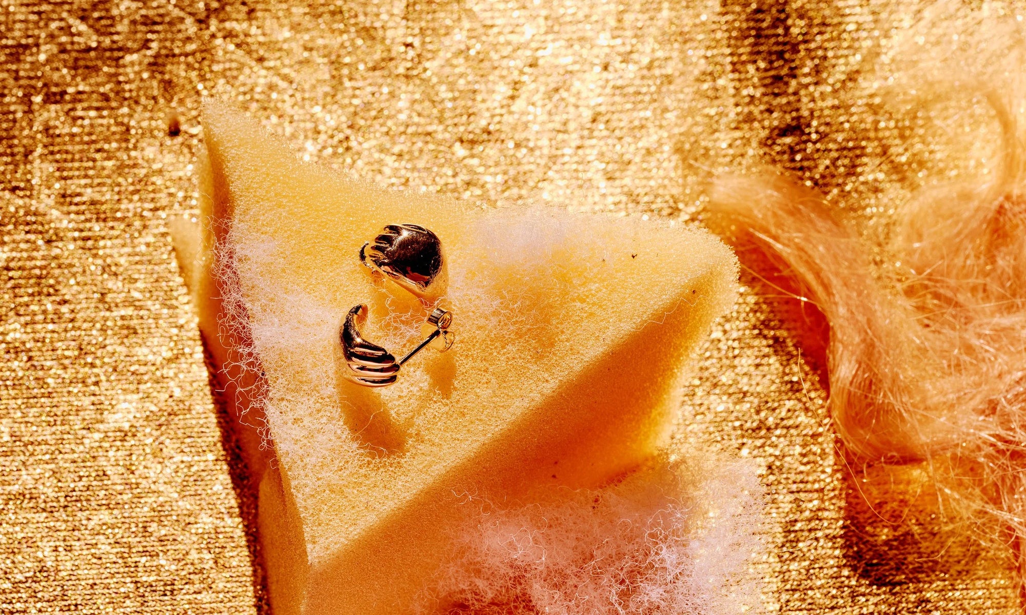 The Held Earrings are a designer's favorite - two tiny hands cupping your earlobes, reminding you that you are held. Handmade in recycled 14k gold.
