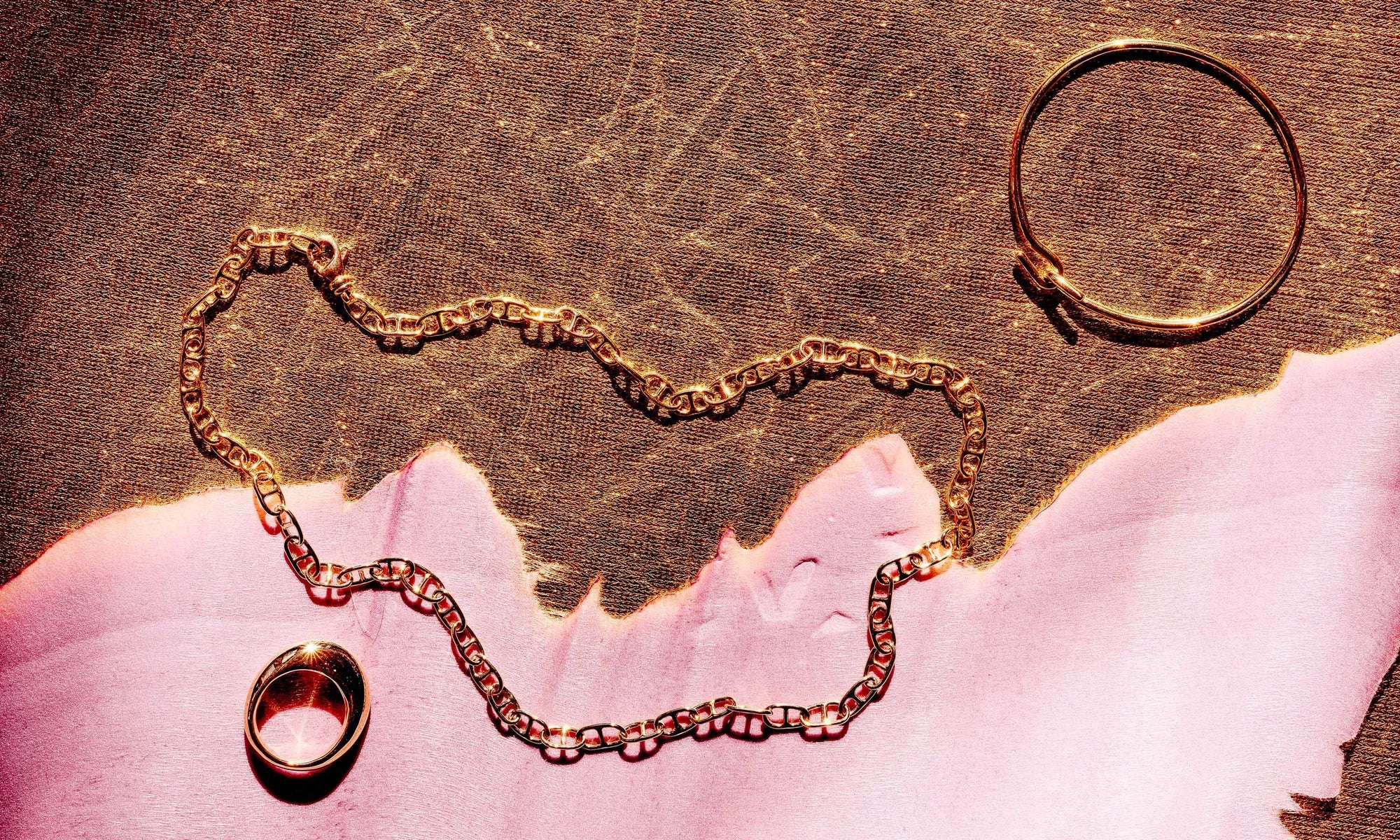 From left: the Persephone Ring, Anchored Handmade Chain, and the Orbit Bracelet. All sustainably handmade in recycled 14k gold.