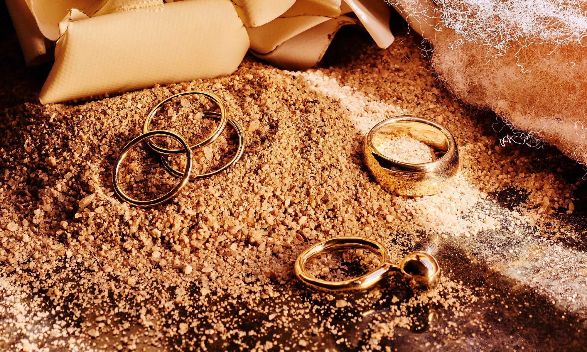 The Infinite Ring Stack, Central Sun Ring and Conjunct Cigar Band, all sustainably handmade in recycled 14k gold.