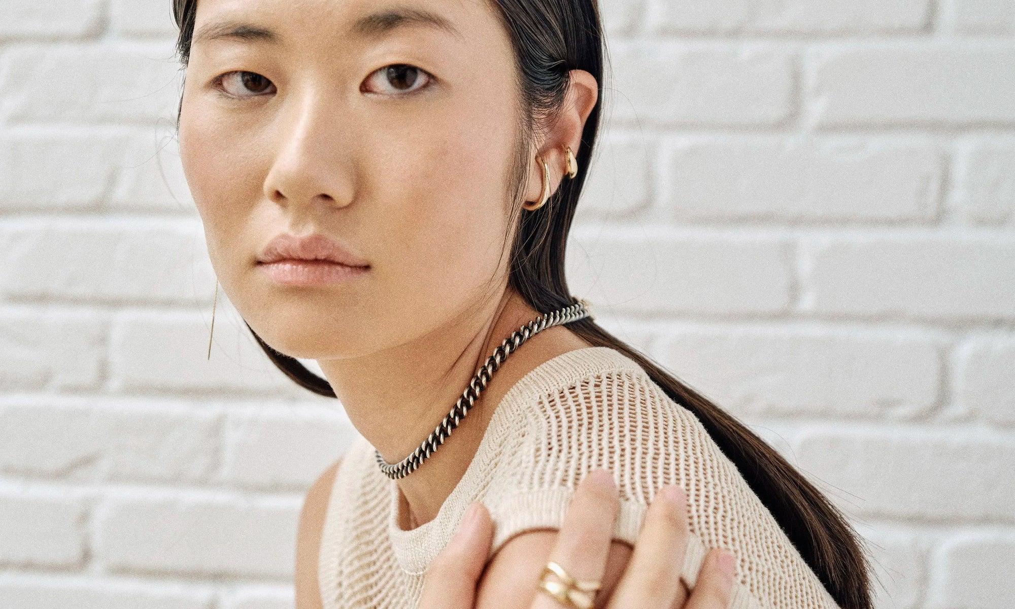 Model Rachel wears the Embrace Earring, Delphi Ear Cuff, and Vortex Chain. All sustainably handmade in solid recycled 14k gold and sterling silver.