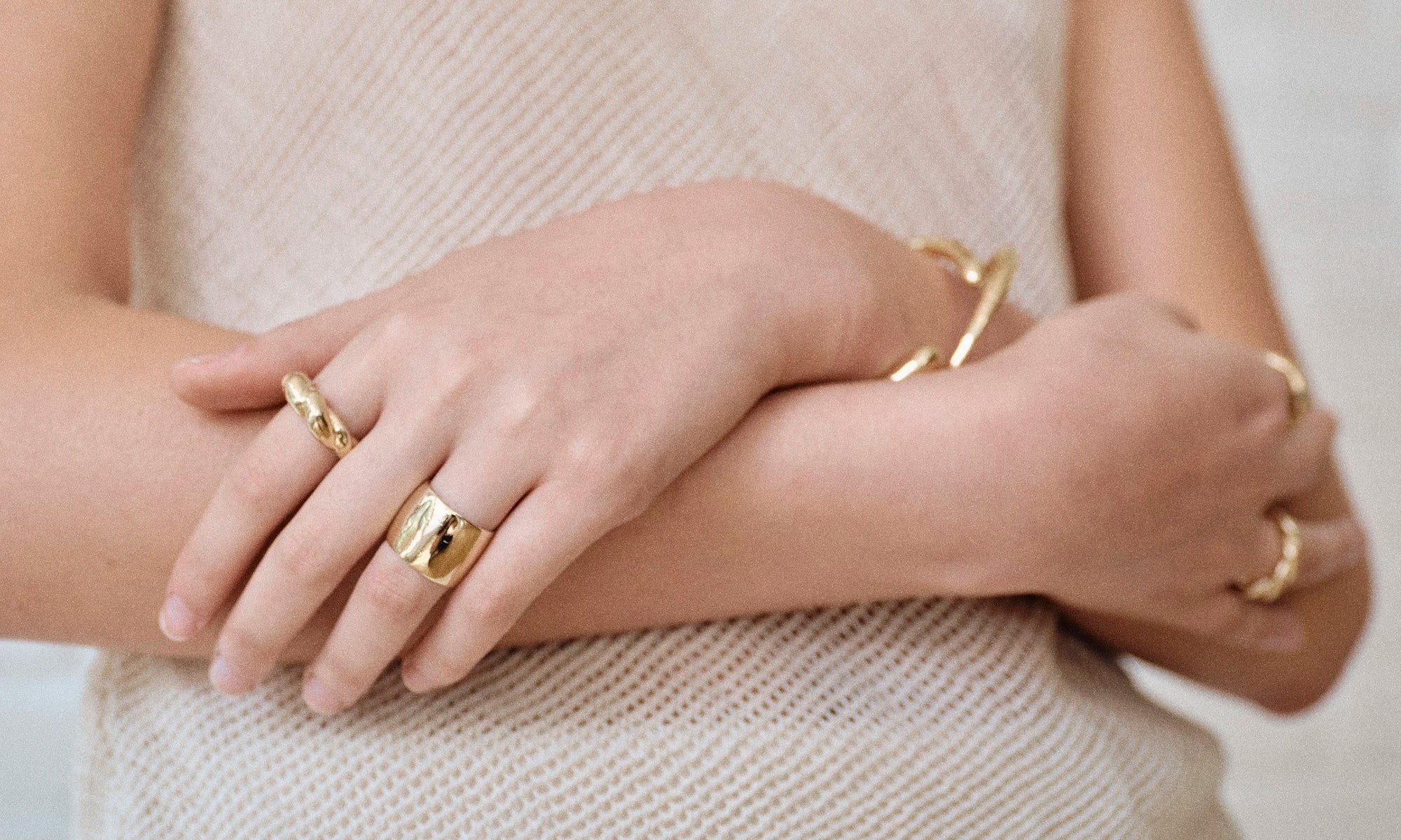 Model Rachel wears the Demeter Cigar Band, Helix Dome Ring, Portal Bracelet and Inverse Cuff. All sustainably handmade in solid recycled 14k gold by Talisman Fine Jewelry.
