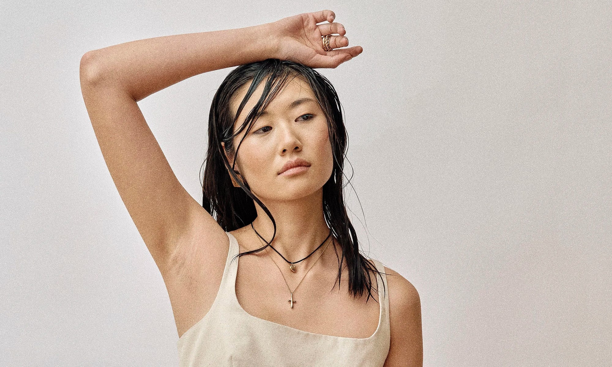 Model Rachel wears the Plane Earrings, Zoe's Heart Necklace on a silk cord and Christ Consciousness Necklace. All sustainably handmade in recycled 14k gold by Talisman Fine Jewelry.