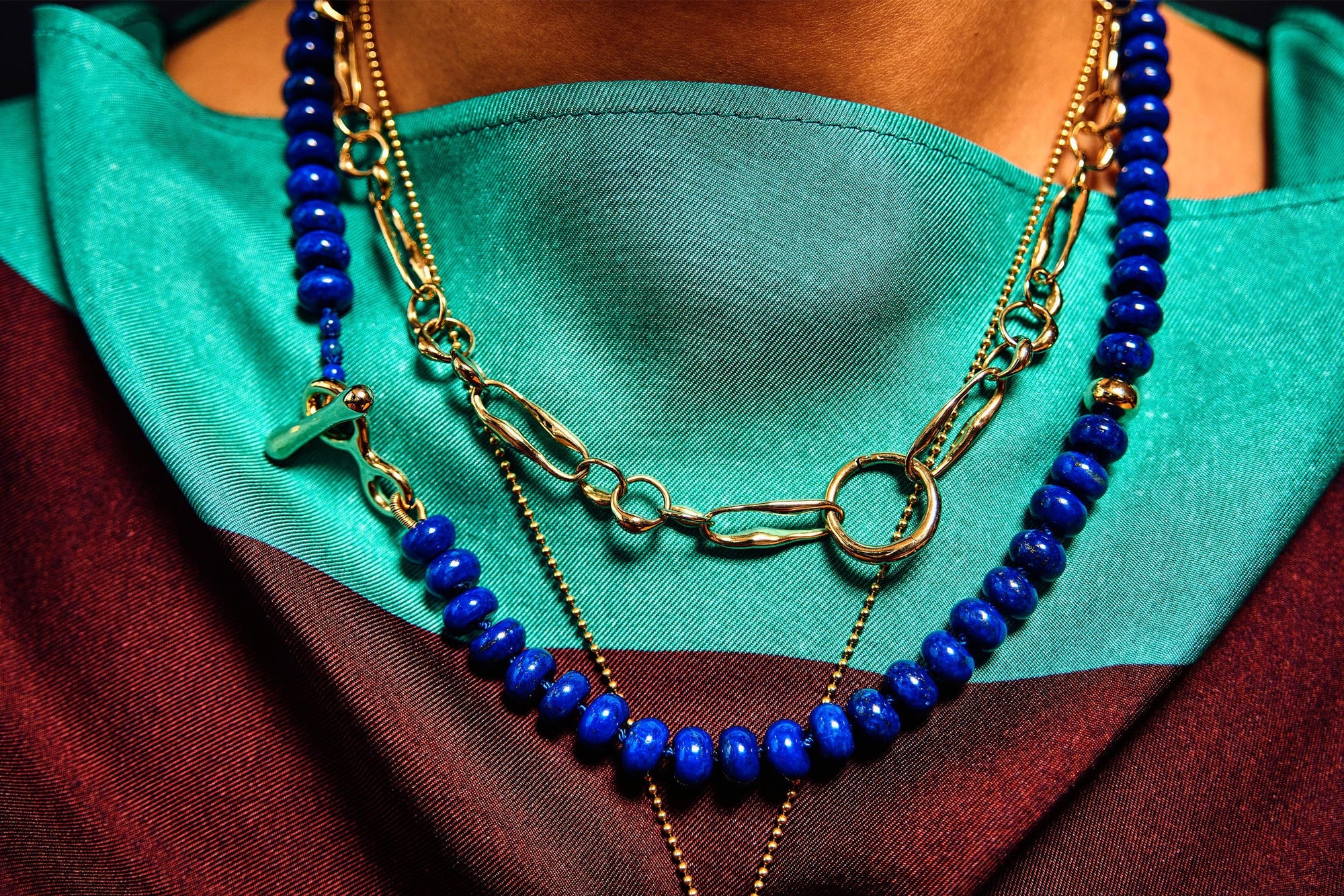 Model Thaiara wears the Metanoia Chain layered with the Prayer Necklace in Lapis, a new addition to the collection that combines hand-knotted silk with polished lapis and handmade gold detailing.