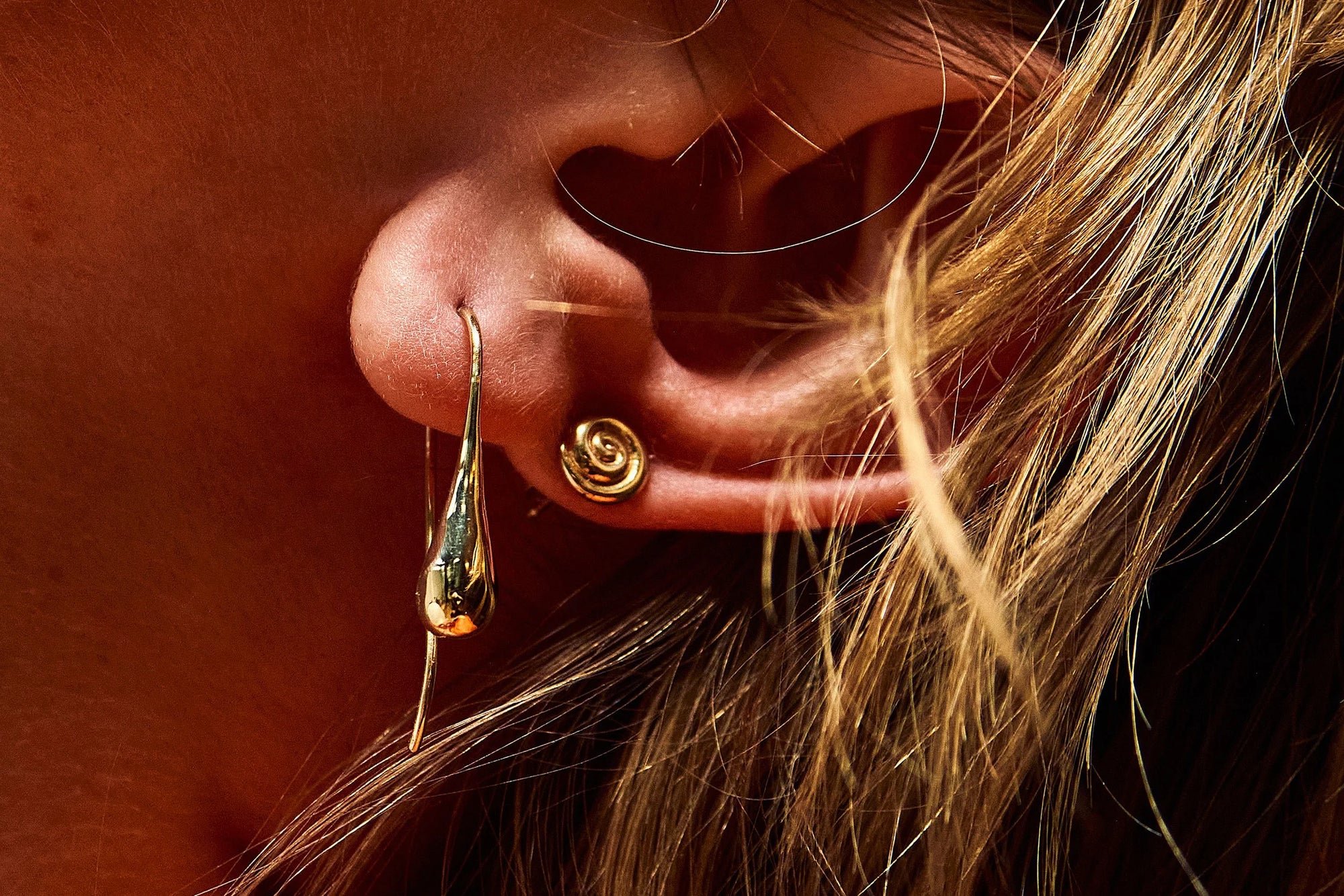 Model Rae wears Sanguine Drop Earrings and Growth Studs.