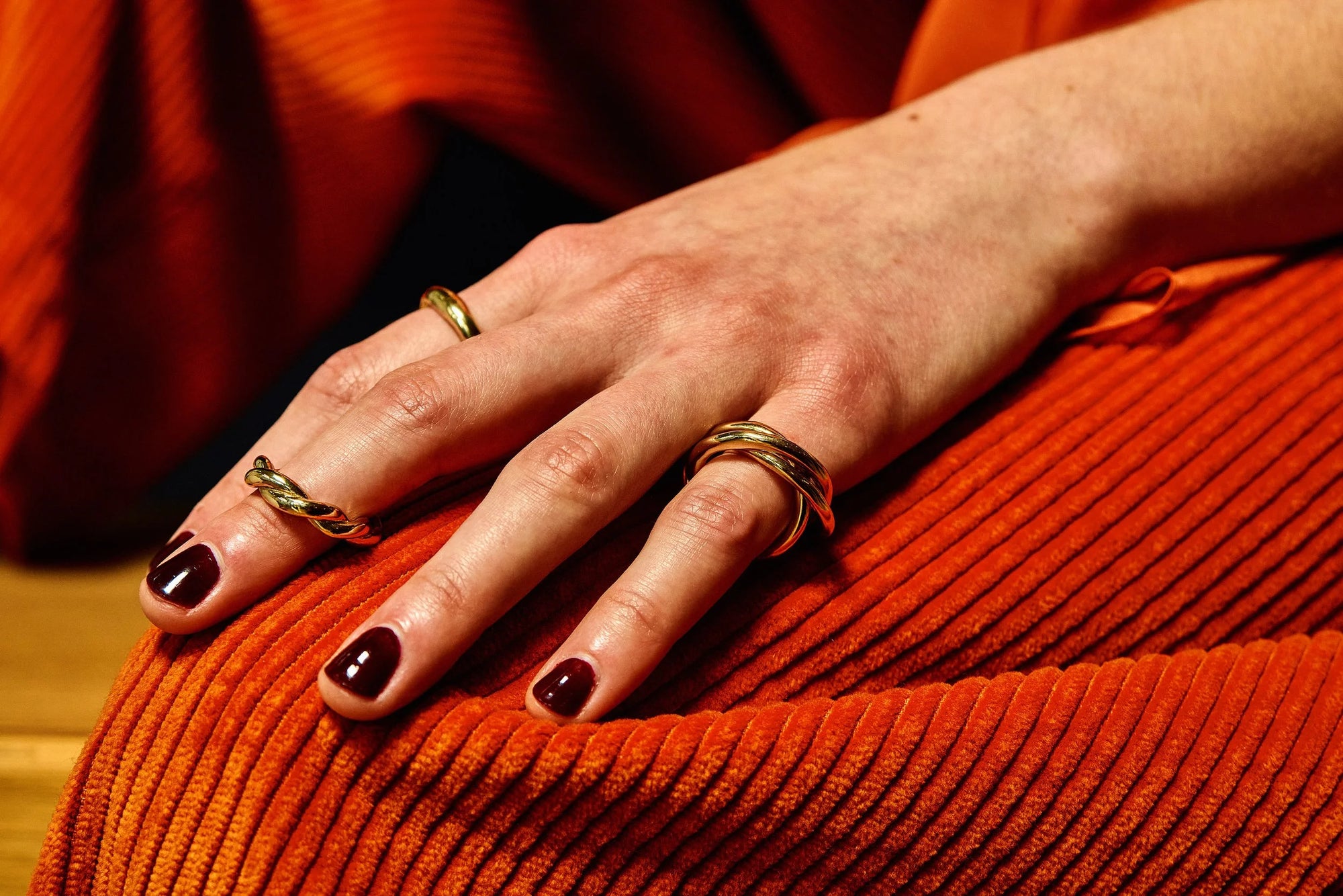 Model Rae wears Rollo Band, Helix Band, and Interconnection Trio Ring.