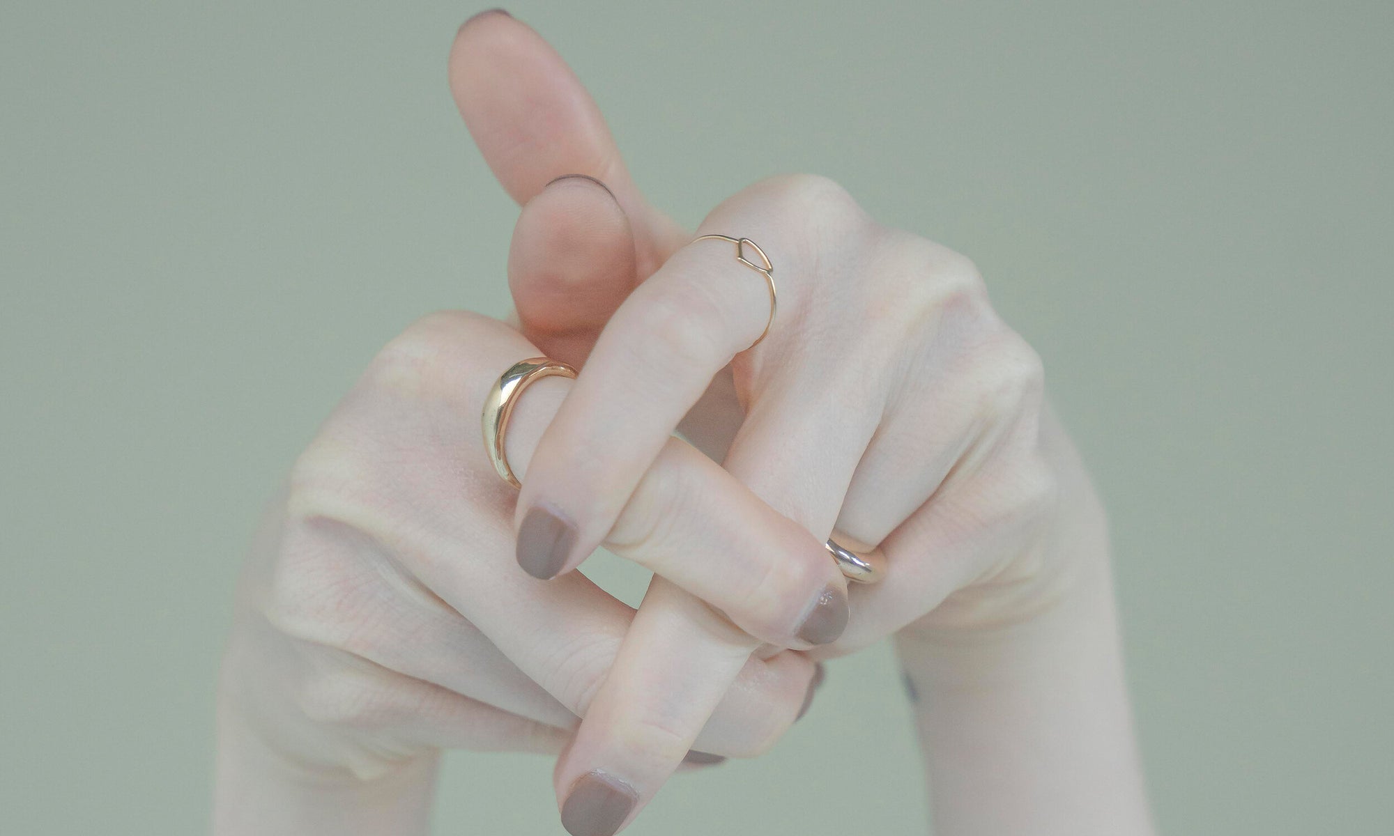 Model Nyasia Wyani wears the Portal Ring, the Triangle Shape Ring, and the Persephone Ring. All sustainably handmade in recycled 14k gold, using traditional lost-wax casting techniques.