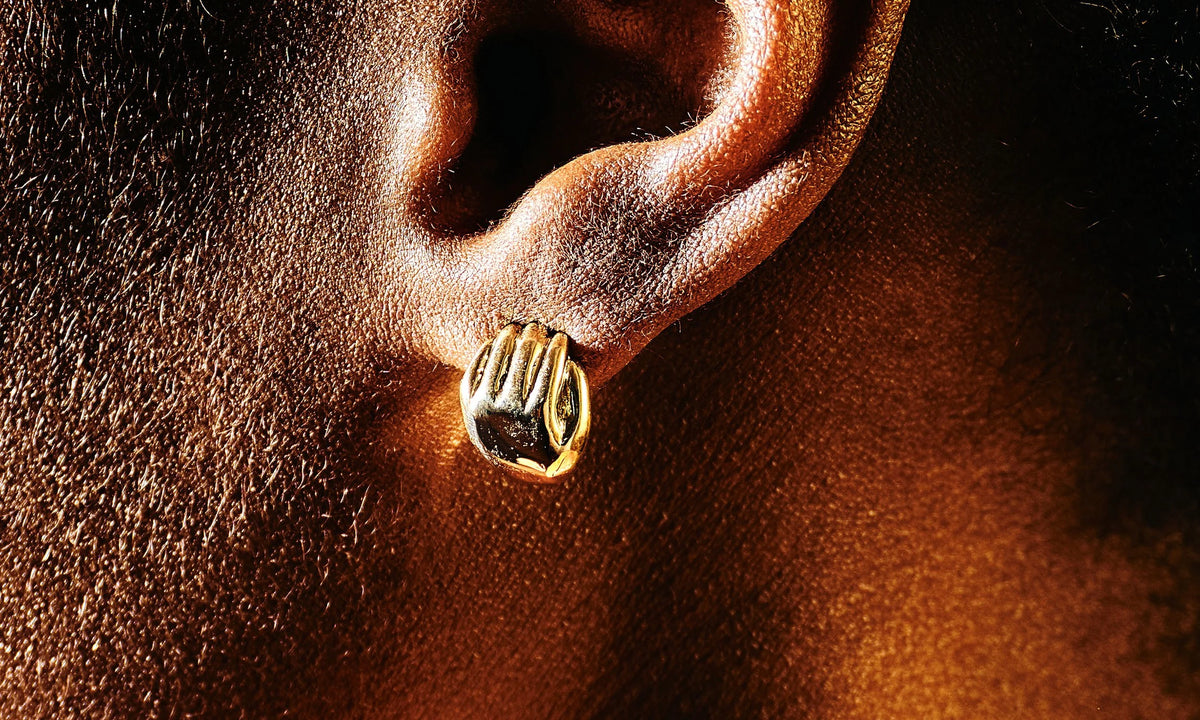 The Held Earrings, a reminder that you are held by the universe. Hand-carved and cast in recycled 14k gold.