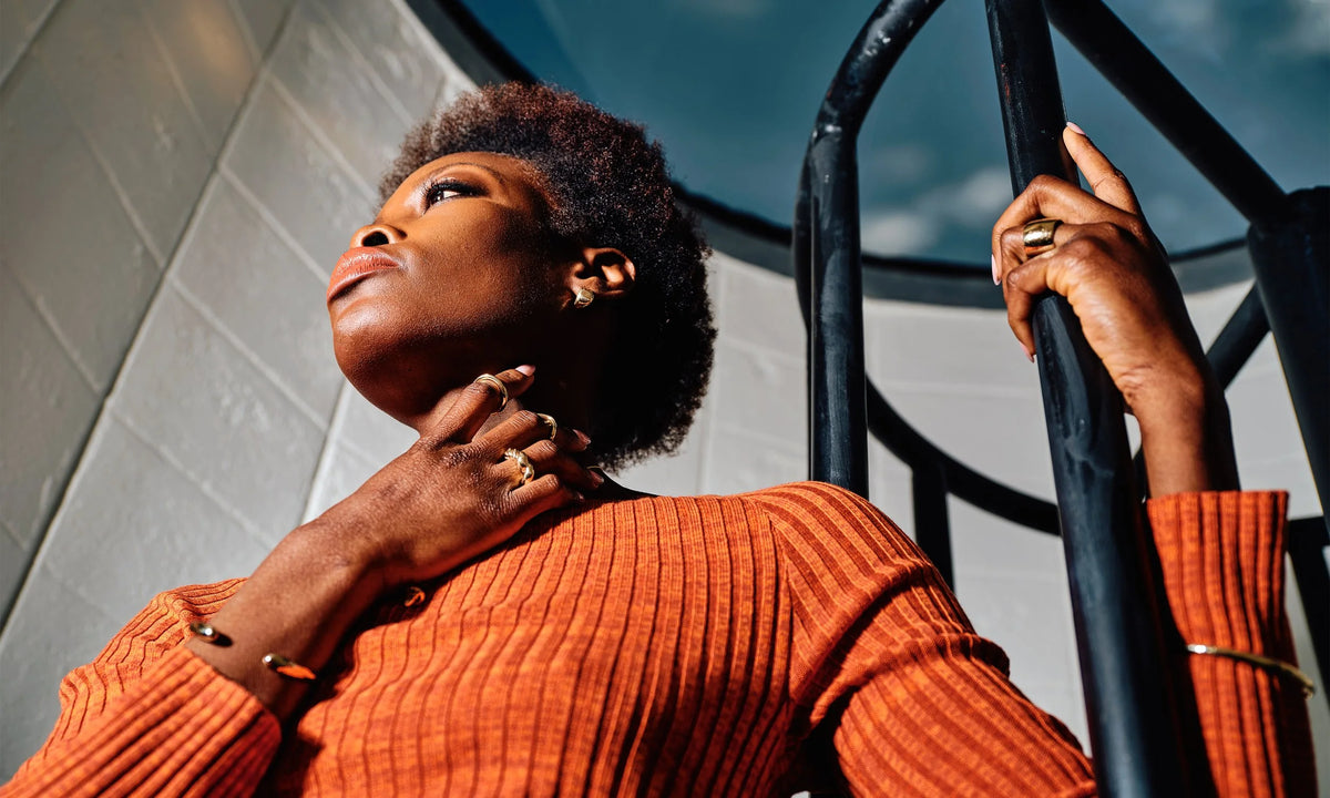 Model Samantha wears, from left: the Inverse Cuff, Helix Ring, Shapeshifter Ring, Petite Rollo Band, Held Earrings, Demeter Cigar Band, and the Portal Bracelet. All hand-sculpted and cast in recycled 14k gold.