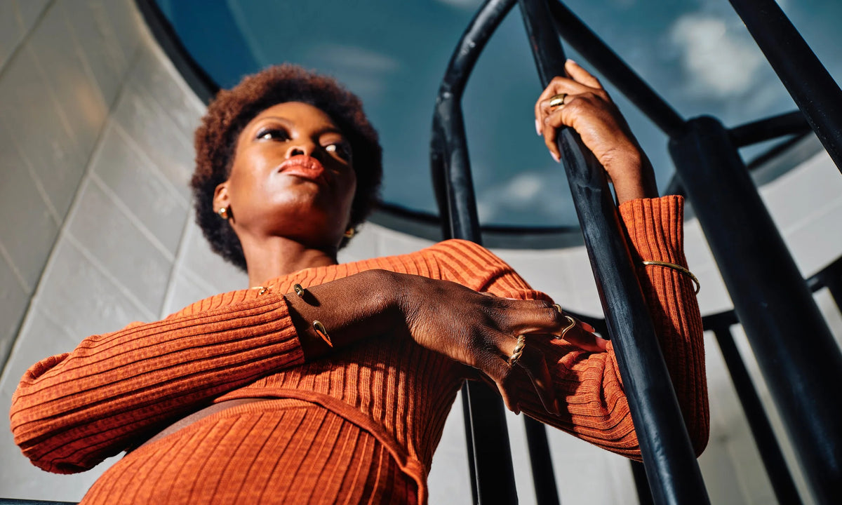 Model Samantha wears, from left: the Inverse Cuff, Helix Ring, Shapeshifter Ring, Petite Rollo Band, Held Earrings, Demeter Cigar Band, and the Portal Bracelet. All hand-sculpted and cast in recycled 14k gold.