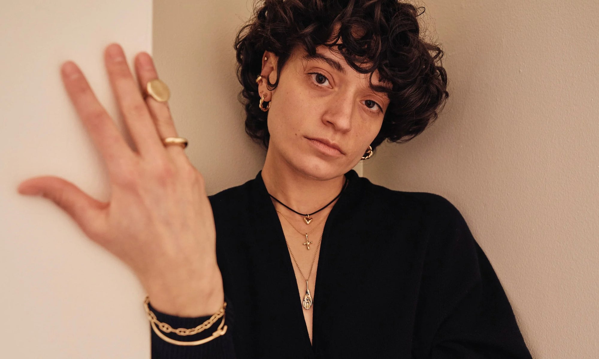 Model Erika Rodriguez wears the Diamond Mini Orb Stud, Delphi Ear Cuff, Outward Arc Stud, Helix Hoops, Zoe's Heart Necklace, Petite Christ Consciousness Necklace, and Held Necklace.