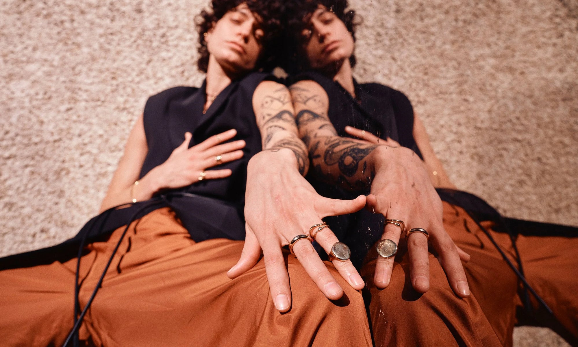 Erika wears the Rollo Band, Shapeshifter Ring, Ouroboros Ring, and the Ra Signet Ring. All hand sculpted and cast in recycled 14k gold.