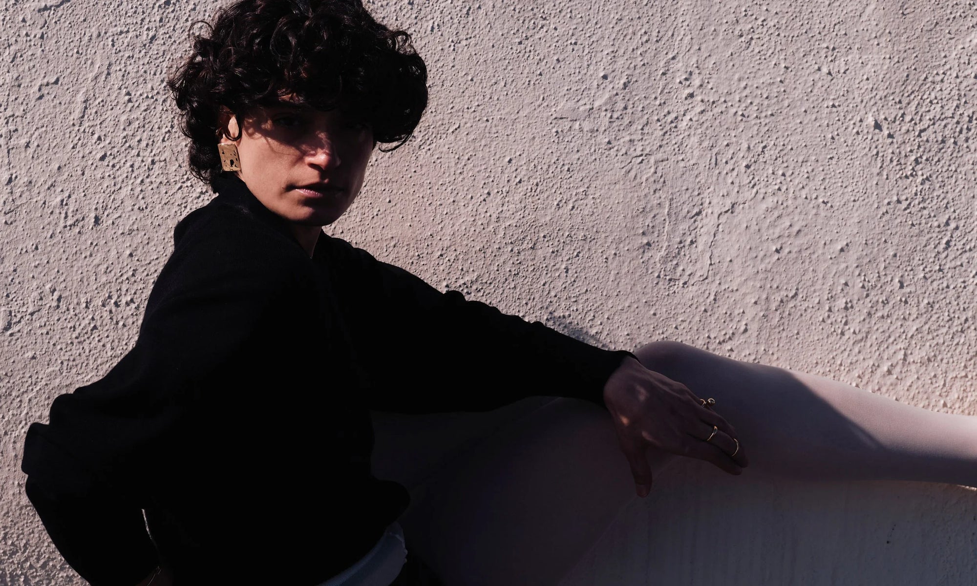 Model Erika Rodriguez wears the Plane Earrings. All sculpted and handmade in solid, recycled 14k gold.