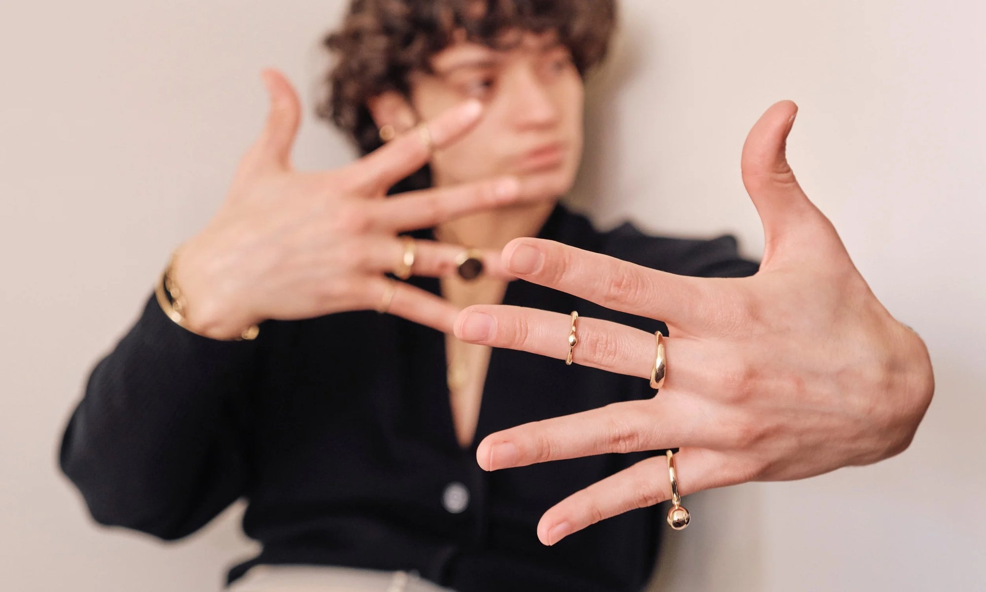 Model Erika Rodriguez wears the Ouroboros Ring, Portal Ring, and Central Sun Ring. All sustainably handmade in recycled 14k gold.