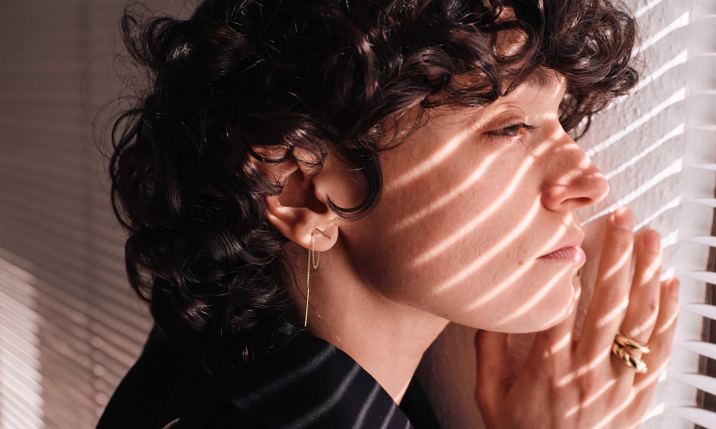 Erika wears the Linear Threader earring, handmade in recycled 14k gold.