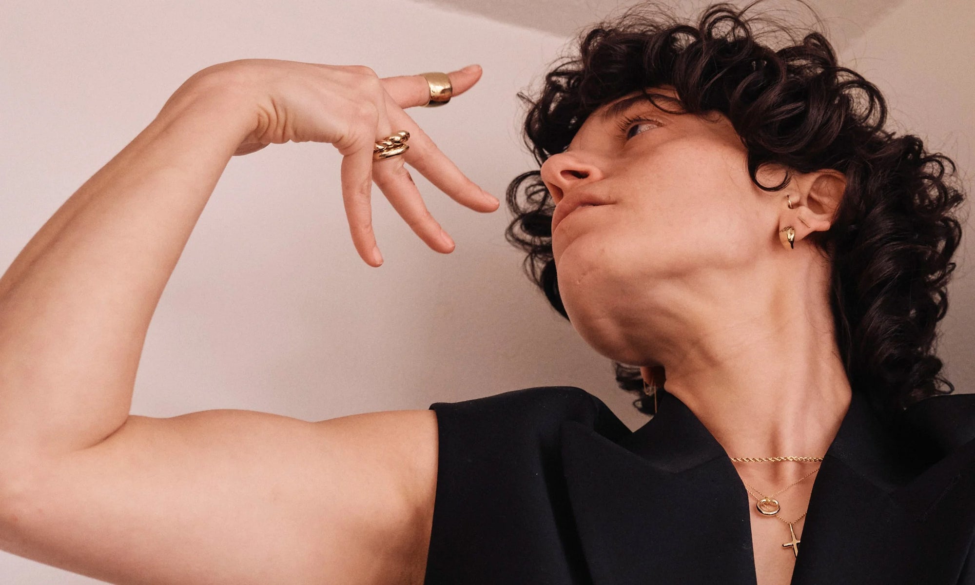 Erika wears the Demeter Cigar Band, Persephone Ring, Helix Dome Ring, Linear Stud, Held Earring, Bound Chain, Ouroboros Necklace, and Christ Consciousness Necklace. All handmade in recycled 14 gold.