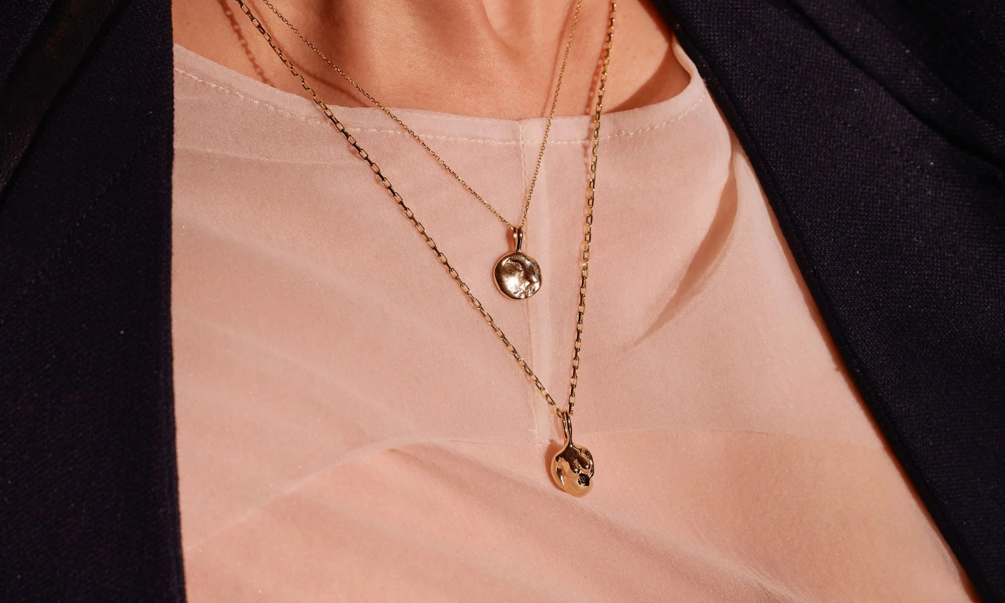 Erika wears the Michael Amulet Necklace and the Soft Body Venus Necklace. Both handmade in recycled 14k gold.