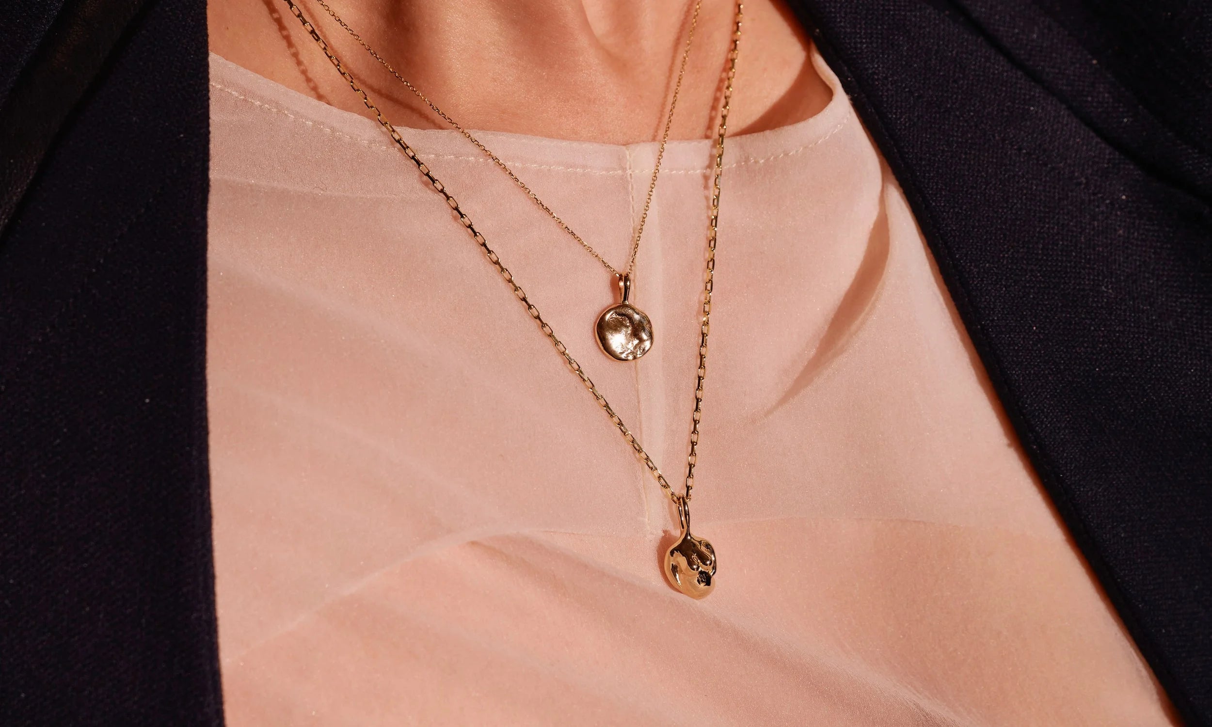 Erika wears the Michael Amulet Necklace and the Soft Body Venus Necklace. Both handmade in recycled 14k gold.