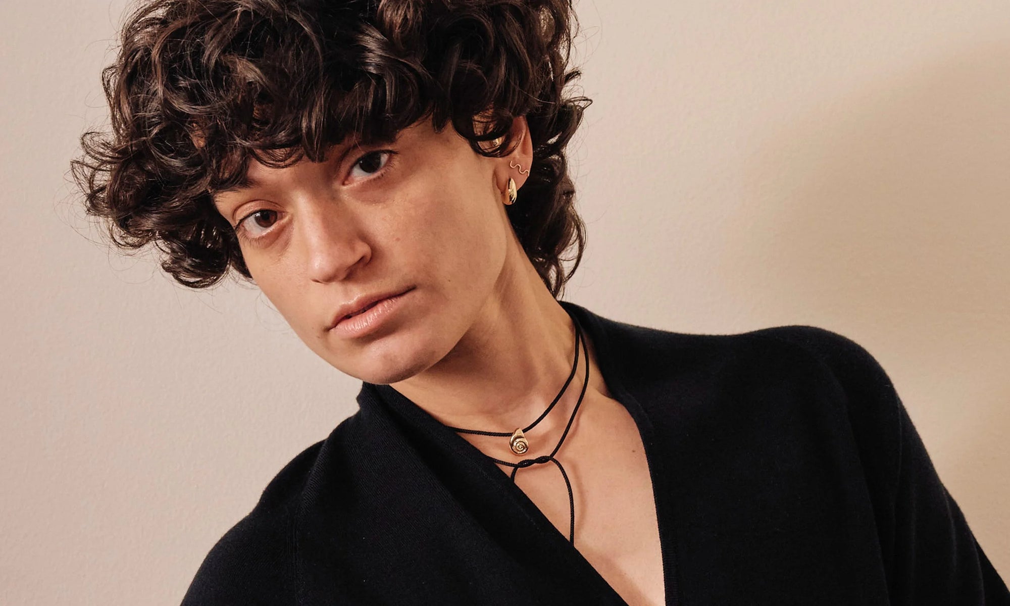 Model Erika Rodriguez wears the Sanguine Stud Earring, Wave Stud, and Growth Necklace on silk cord.