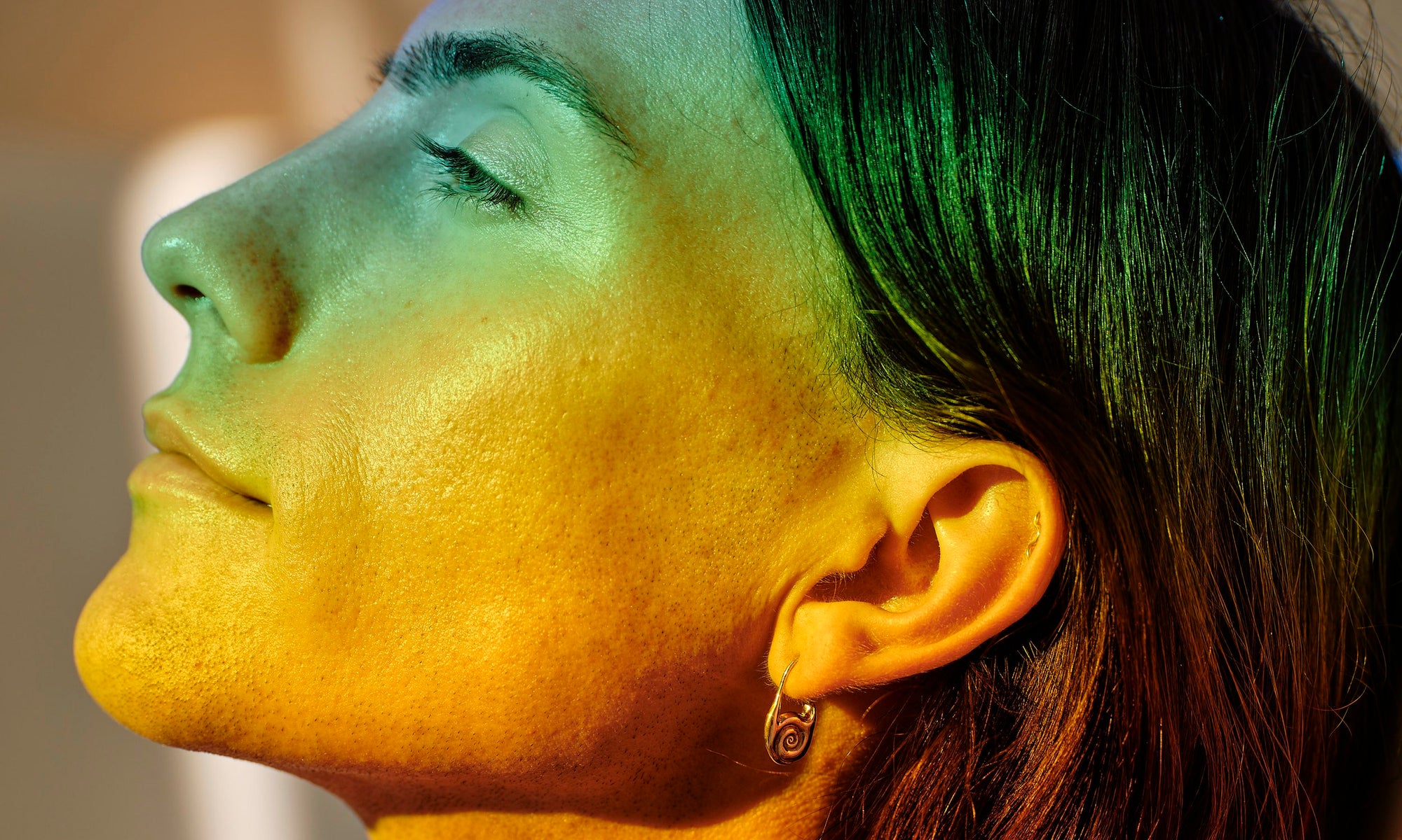 Hand-sculpted spiral earrings cast in ethically-sourced recycled 14k gold, made by Talisman Fine Jewelry. Apple wears the Journey Hoops.