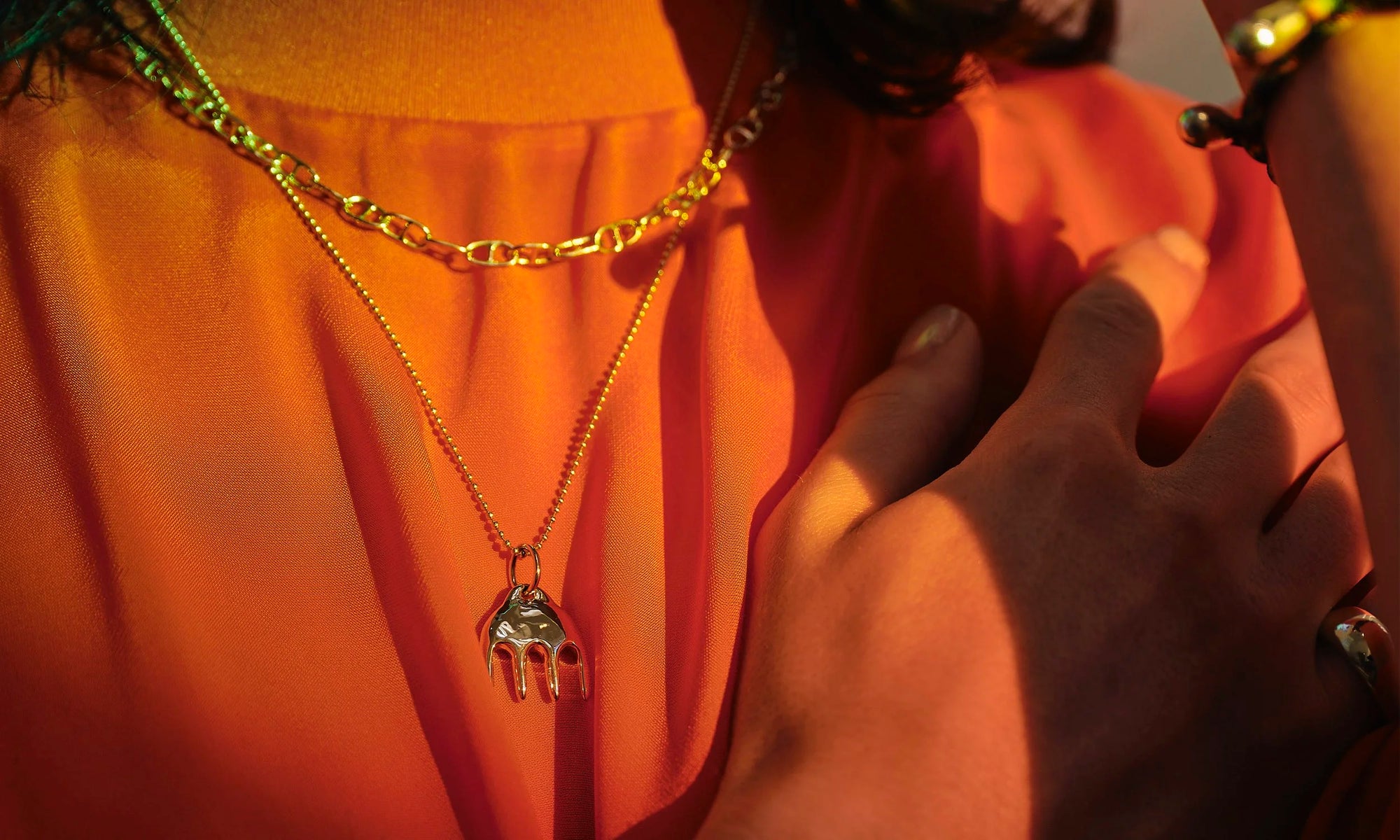 Handmade gold chain necklace and 14k solid gold abstract pendant made by Talisman Fine Jewelry. Apple wears the Anchored Handmade Chain and Ariel's Comb Necklace.