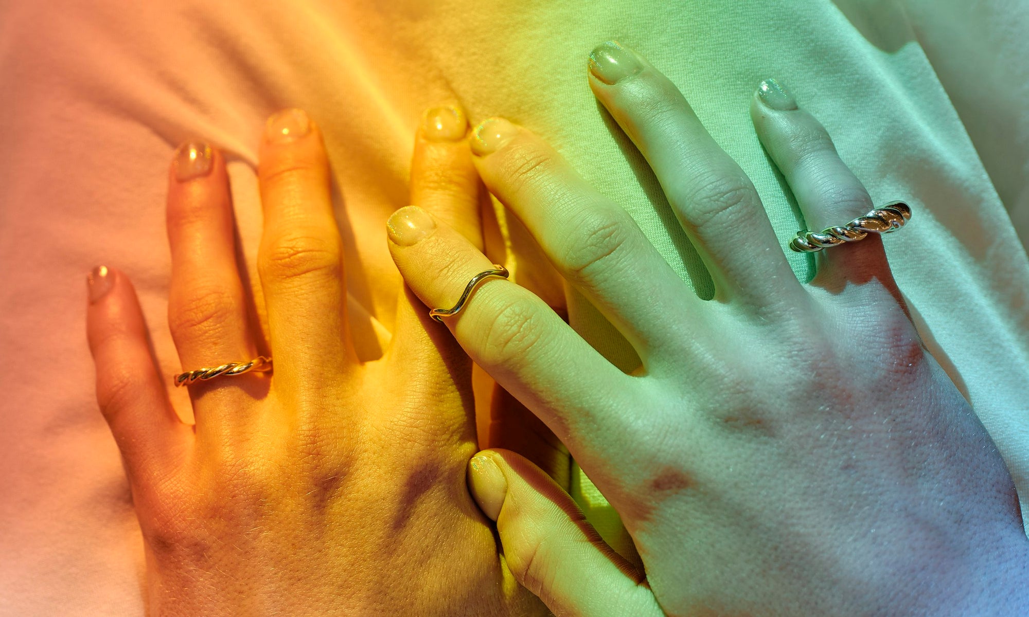 Minimalist, sustainably sourced recycled 14k gold rings with reclaimed diamonds handmade by Talisman Fine Jewelry. Apple wears the Petite Helix Band, Wave Theory Ring, and Helix Dome Ring.