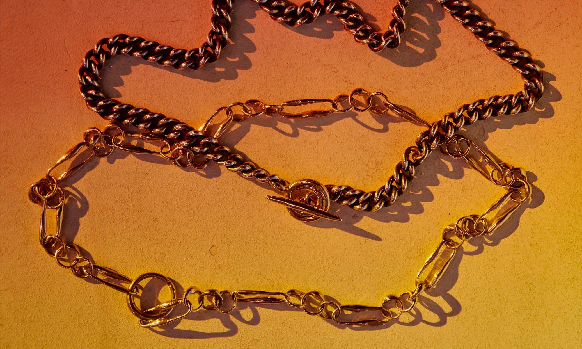 Hand-sculpted and cast sustainably sourced jewelry made from recycled 14k gold with silver chain details. Talisman's SS25 collection featuring the Vortex Chain Necklace and the Metanoia Handmade Chain.