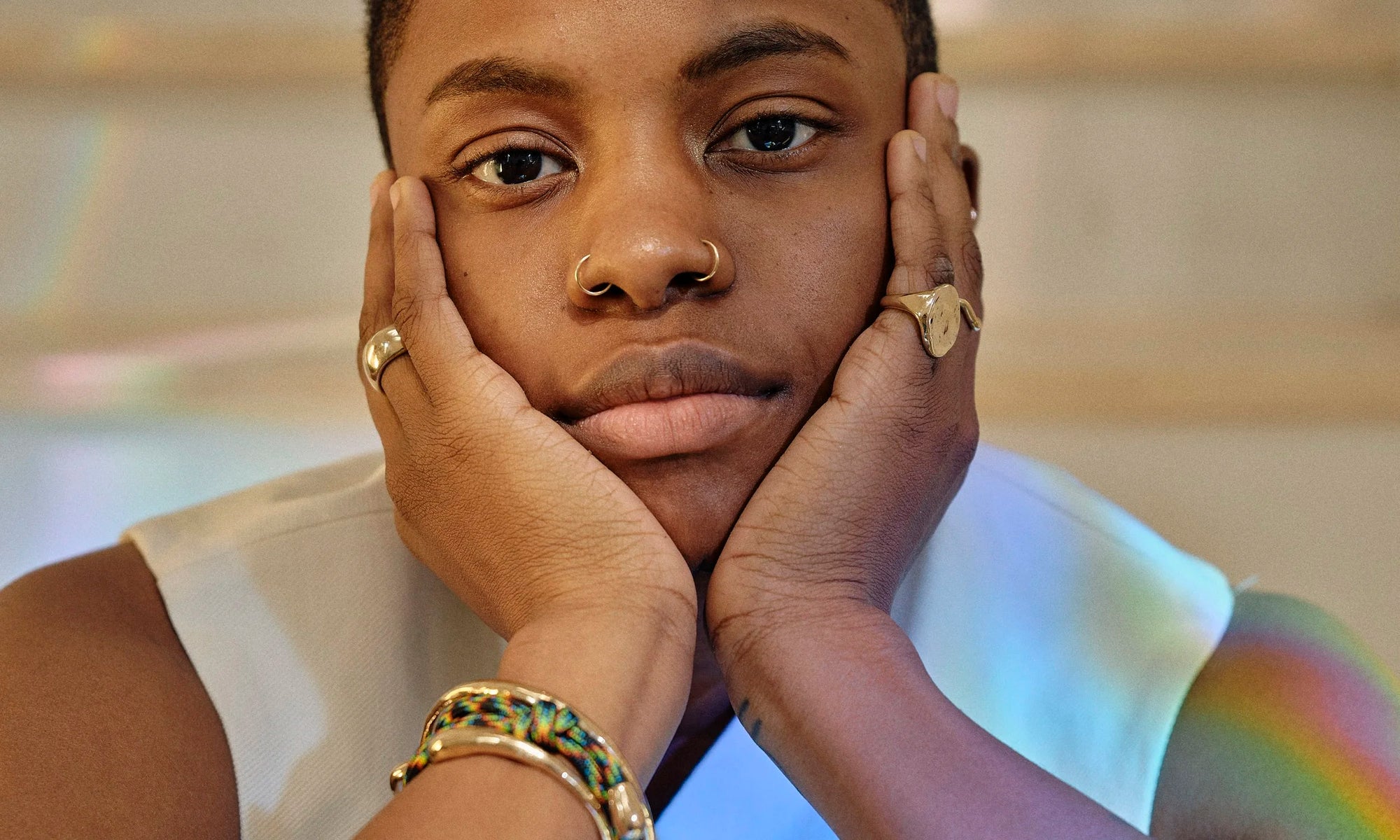 Hand-sculpted minimal gold rings and bracelets rings made from ethically sourced recycled 14k gold by Talisman Fine Jewelry. Royal wears the Dance Bracelet, Inverse Cuff Bracelet, Portal Bracelet, Conjunct Cigar Band, and Ra Pinky Signet Ring.