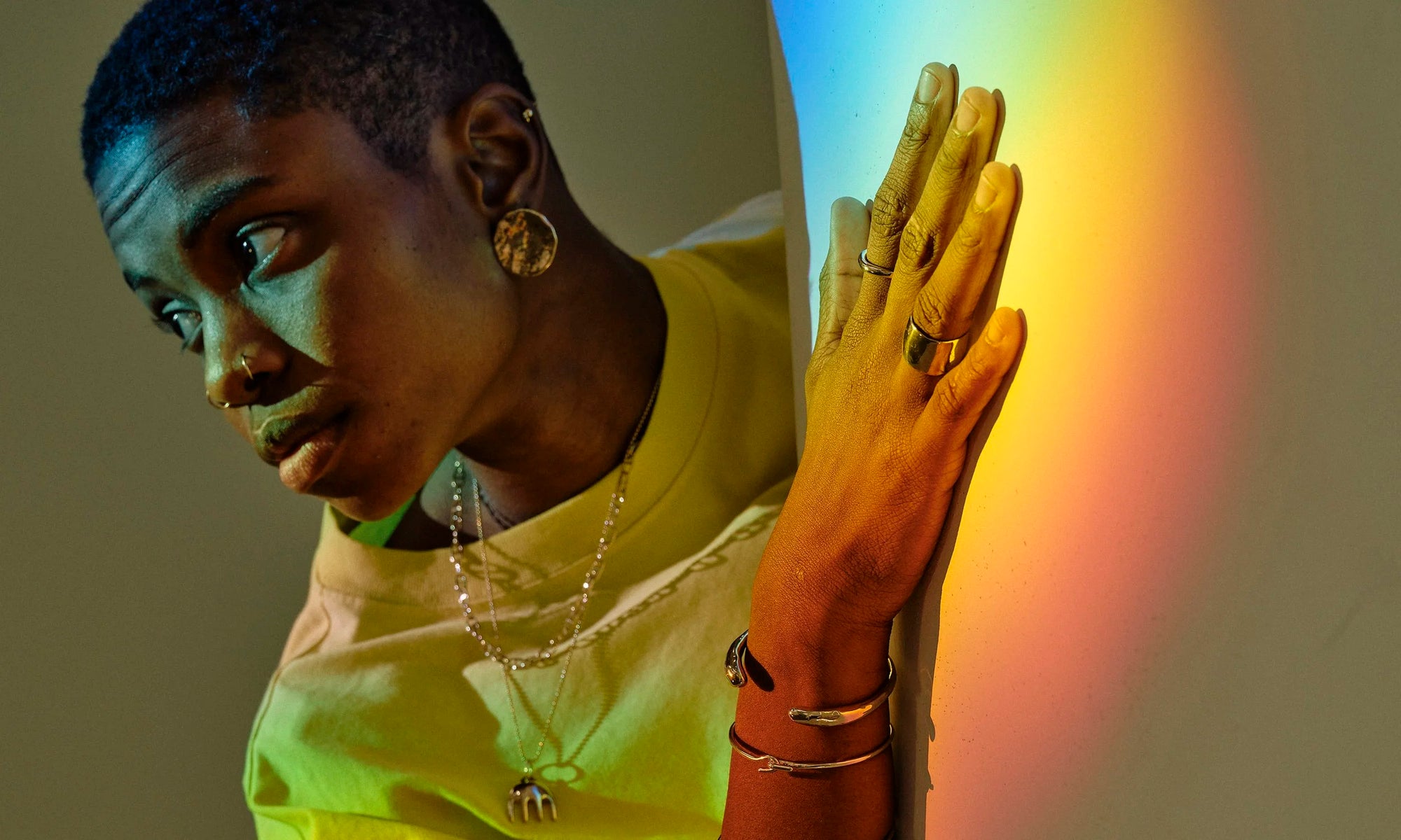 Recycled 14k solid gold rings and minimal statement jewelry, hand-sculpted and ethically sourced by Talisman Fine Jewelry. Royal wears the Demeter Cigar Band, Petite Rollo Band, Orb Earring, Diamond Mini Orb Stud, Inverse Cuff, Orbit Bracelet, Anchored Handmade Chain and Ariel's Comb Necklace.