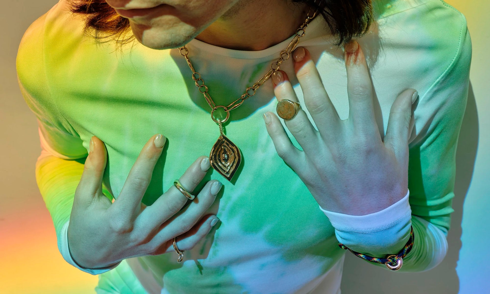 Hand-sculpted, sustainably sourced 14k gold jewelry made from recycled gold by Talisman Fine Jewelry. Apple wears the Dance Bracelet, Interdependence Ring, Persephone Ring, Ra Pinky Signet, and Metanoia with Mary Pendant Chain Set.