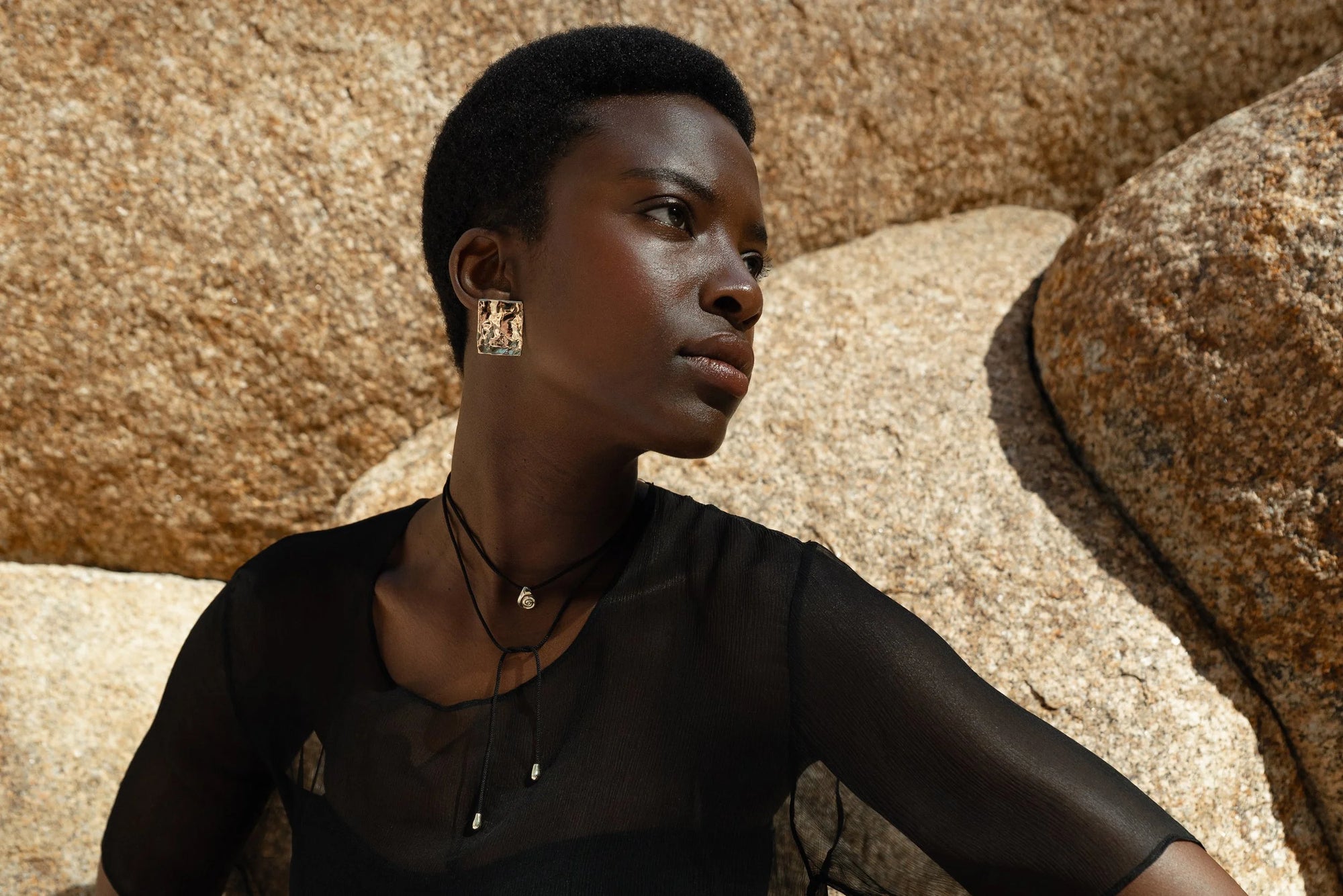 Anna wears the Plane Earrings with the Growth Necklace on Silk Cord.