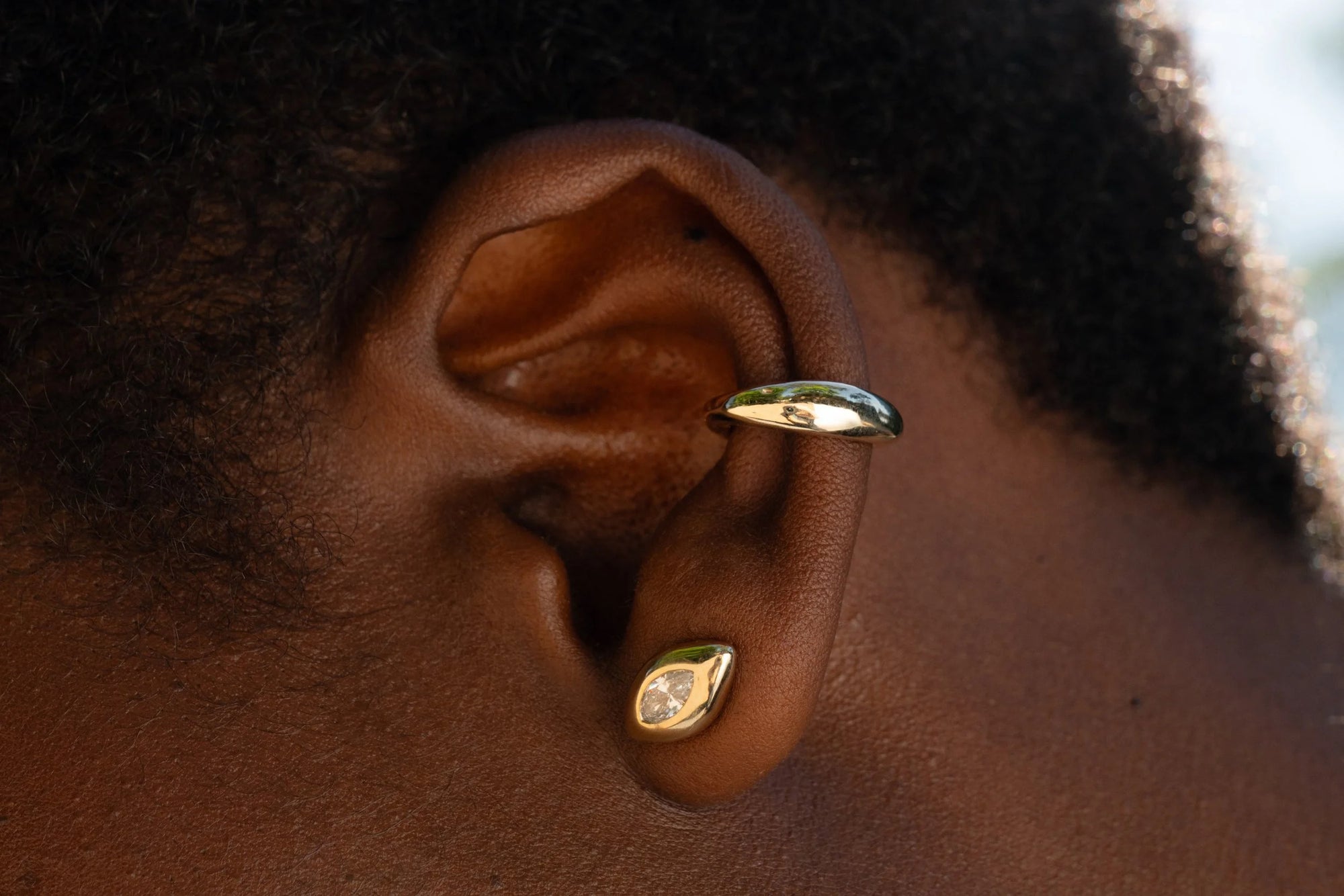 The Sibyl Ear Cuff and the Horus Stud with reclaimed marquise diamond. Both sustainably handmade in 14k recycled gold.