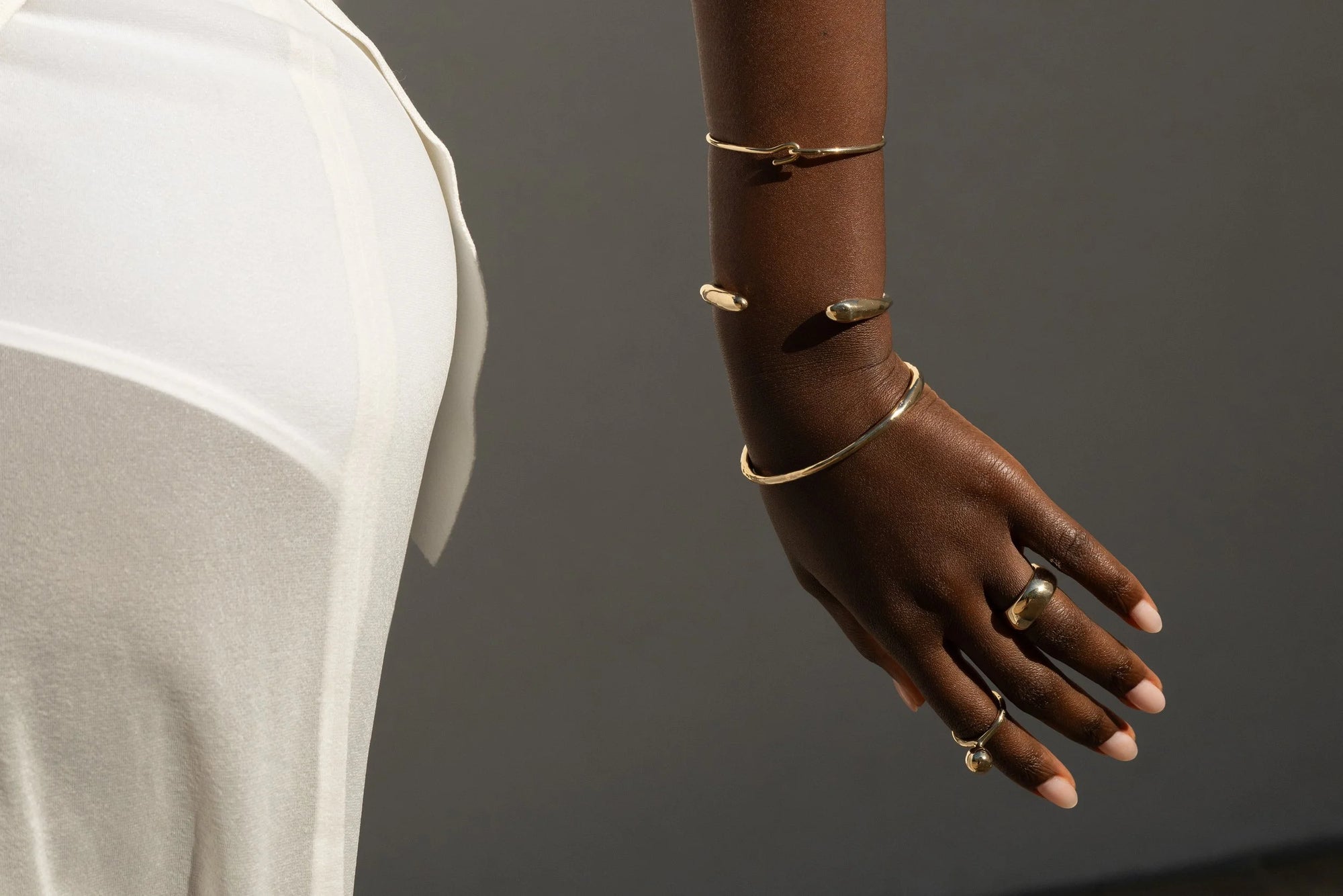 From top: Anna wears the Orbit Bracelet, Inverse Cuff, Portal Bracelet, Conjuct Cigar Band and Central Sun Ring.