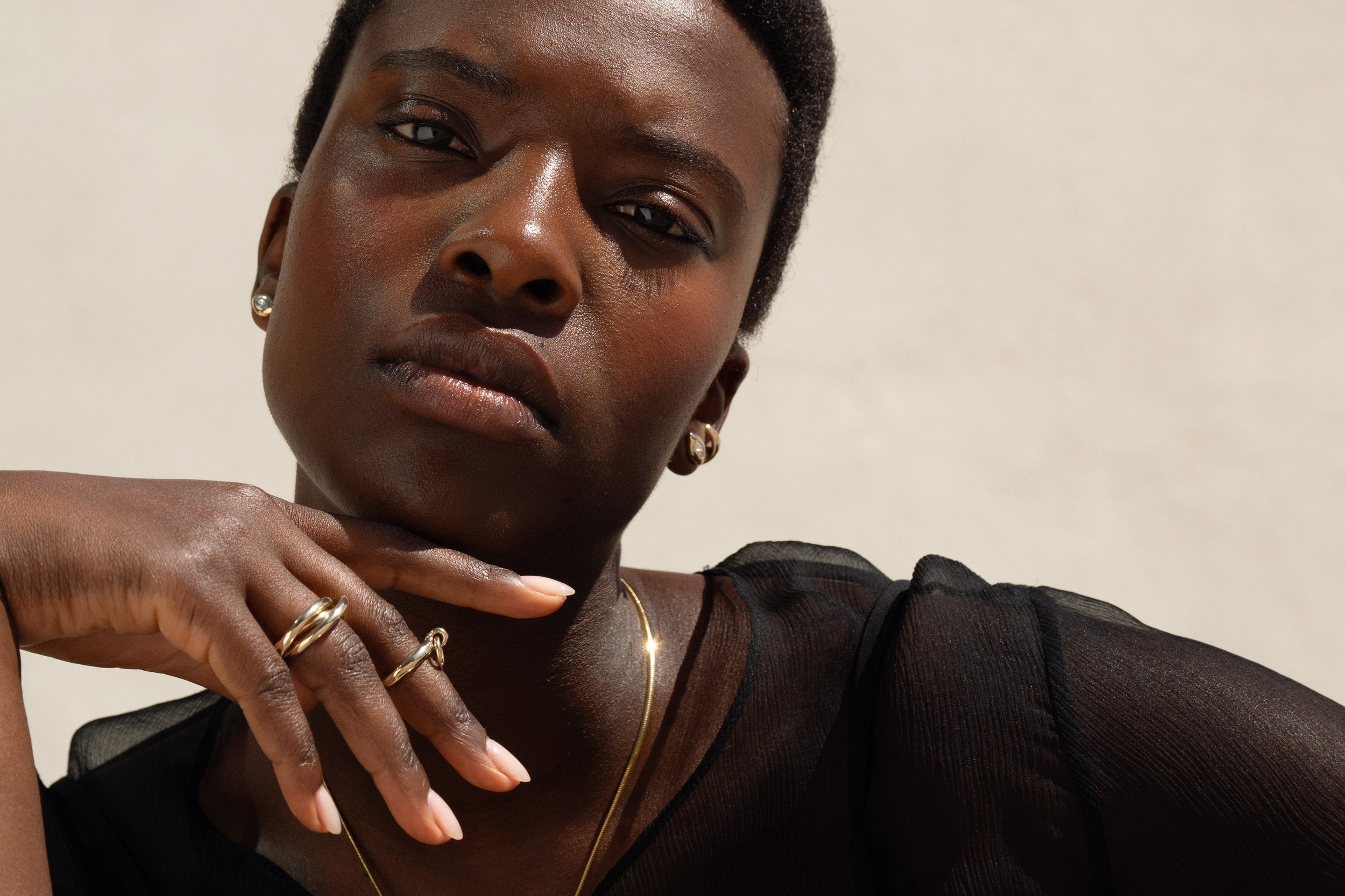 Anna wears the Sibyl Ear Cuff, Horus Studs with marquise diamonds, paired with the Interconnection Trio Ring and Interdependence Ring.
