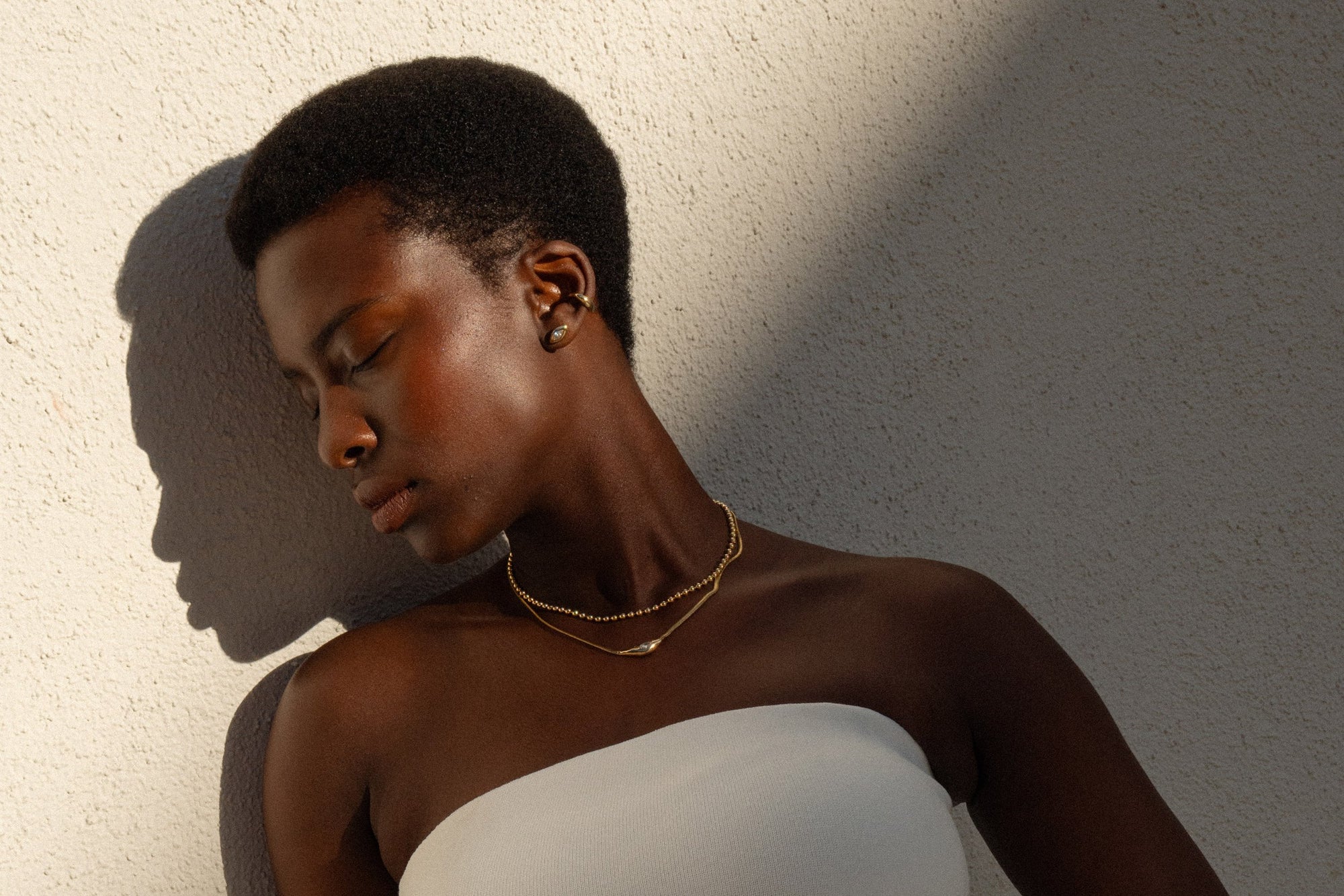 From top: Sybil Ear Cuff, marquis diamond Horus Studs, Gold Galaxy Chain and Where the Light Comes Through Necklace.