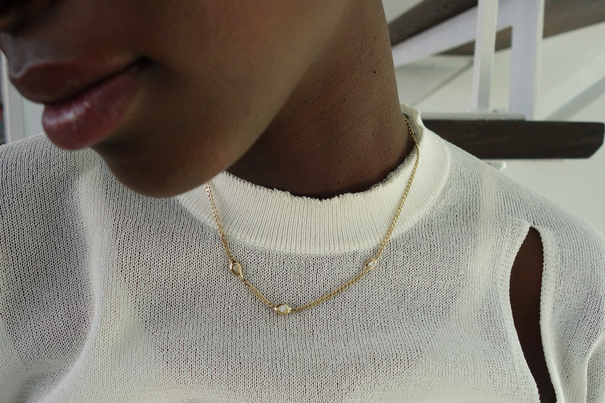 talisman fine jewelry fall 2026 constellation necklace, with three asymmetrically placed gold blobby shapes, each set with a different mismatched diamond on a curb chain